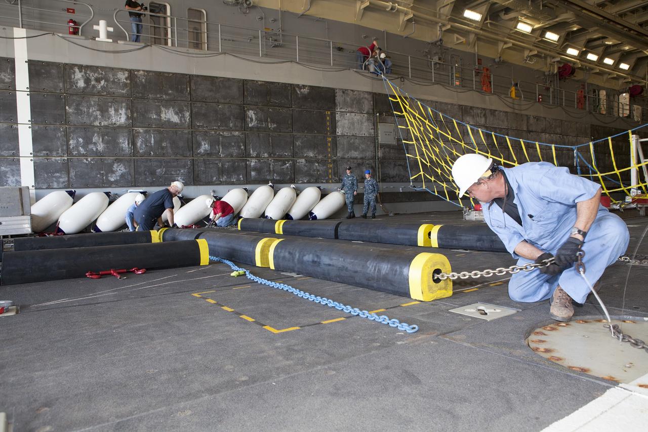 SAN DIEGO, Calif. – Ground support equipment is being secured in the well deck of the USS Anchorage at Naval Base San Diego in California. The equipment will be used during recovery of the Orion crew module after its first flight test. Before launch of Orion on a Delta IV Heavy rocket from Cape Canaveral Air Force Station in Florida, NASA, Lockheed Martin and U.S. Navy personnel will head out to sea in the USS Anchorage and the USNS Salvor, a salvage ship, and wait for splashdown of the Orion crew module in the Pacific Ocean.    The Ground Systems Development and Operations Program will lead the recovery efforts. Orion is the exploration spacecraft designed to carry astronauts to destinations not yet explored by humans, including an asteroid and Mars. It will have emergency abort capability, sustain the crew during space travel and provide safe re-entry from deep space return velocities. The first unpiloted flight test of Orion is scheduled to launch in December atop a United Launch Alliance Delta IV Heavy rocket and in 2018 on NASA’s Space Launch System rocket. For more information, visit http://www.nasa.gov/orion. Photo credit: NASA/Dimitri Gerondidakis
