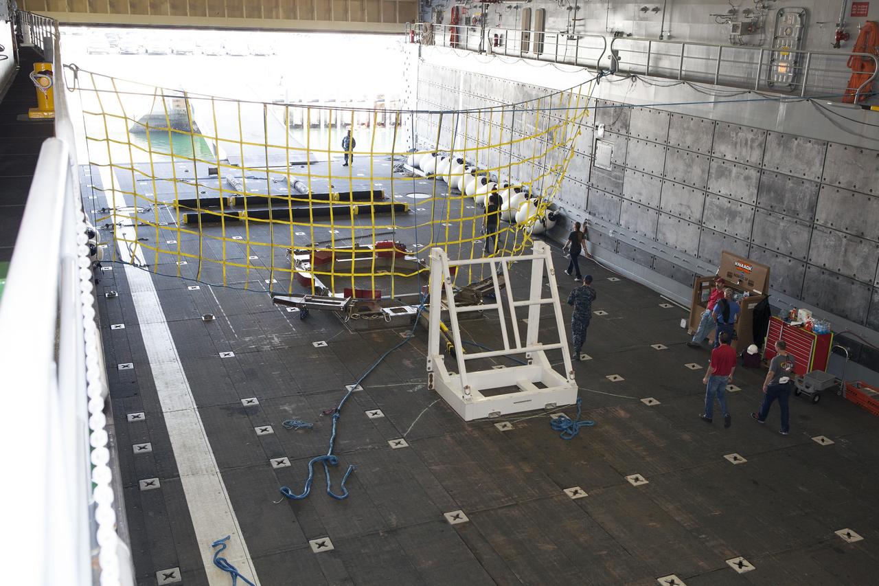 SAN DIEGO, Calif. – The Orion handling fixture and other ground support equipment is secured in the well deck of the USS Anchorage at Naval Base San Diego in California. The equipment will be used during recovery of the Orion crew module after its first flight test. Before launch of Orion on a Delta IV Heavy rocket from Cape Canaveral Air Force Station in Florida, NASA, Lockheed Martin and U.S. Navy personnel will head out to sea in the USS Anchorage and the USNS Salvor, a salvage ship, and wait for splashdown of the Orion crew module in the Pacific Ocean. The Ground Systems Development and Operations Program will lead the recovery efforts. Orion is the exploration spacecraft designed to carry astronauts to destinations not yet explored by humans, including an asteroid and Mars. It will have emergency abort capability, sustain the crew during space travel and provide safe re-entry from deep space return velocities. The first unpiloted flight test of Orion is scheduled to launch in December atop a United Launch Alliance Delta IV Heavy rocket and in 2018 on NASA’s Space Launch System rocket. For more information, visit http://www.nasa.gov/orion. Photo credit: NASA/Dimitri Gerondidakis