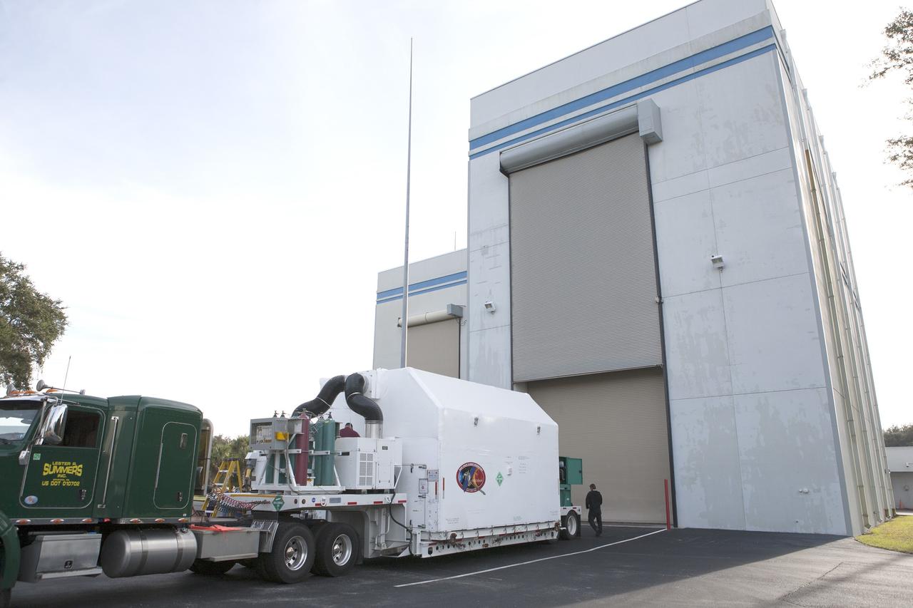CAPE CANAVERAL, Fla. – The truck delivering NOAA’s Deep Space Climate Observatory spacecraft, or DSCOVR, enclosed in a protective shipping container, backs up to the door of the airlock of Building 2 at the Astrotech payload processing facility in Titusville, Florida, near Kennedy Space Center. DSCOVR is a partnership between NOAA, NASA and the U.S. Air Force. DSCOVR will maintain the nation's real-time solar wind monitoring capabilities which are critical to the accuracy and lead time of NOAA's space weather alerts and forecasts. Launch is currently scheduled for January 2015 aboard a SpaceX Falcon 9 v 1.1 launch vehicle from Cape Canaveral Air Force Station, Florida. To learn more about DSCOVR, visit http://www.nesdis.noaa.gov/DSCOVR. Photo credit: NASA/Kim Shiflett