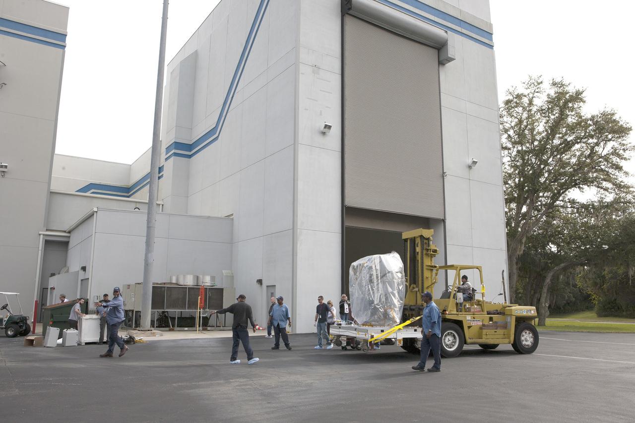 CAPE CANAVERAL, Fla. – NOAA’s Deep Space Climate Observatory spacecraft, or DSCOVR, wrapped in plastic and secured onto a portable work stand, makes a short trek from the airlock of Building 2 to the high bay of Building 1 at the Astrotech payload processing facility in Titusville, Florida, near Kennedy Space Center. DSCOVR is a partnership between NOAA, NASA and the U.S. Air Force. DSCOVR will maintain the nation's real-time solar wind monitoring capabilities which are critical to the accuracy and lead time of NOAA's space weather alerts and forecasts. Launch is currently scheduled for January 2015 aboard a SpaceX Falcon 9 v 1.1 launch vehicle from Cape Canaveral Air Force Station, Florida. To learn more about DSCOVR, visit http://www.nesdis.noaa.gov/DSCOVR. Photo credit: NASA/Kim Shiflett
