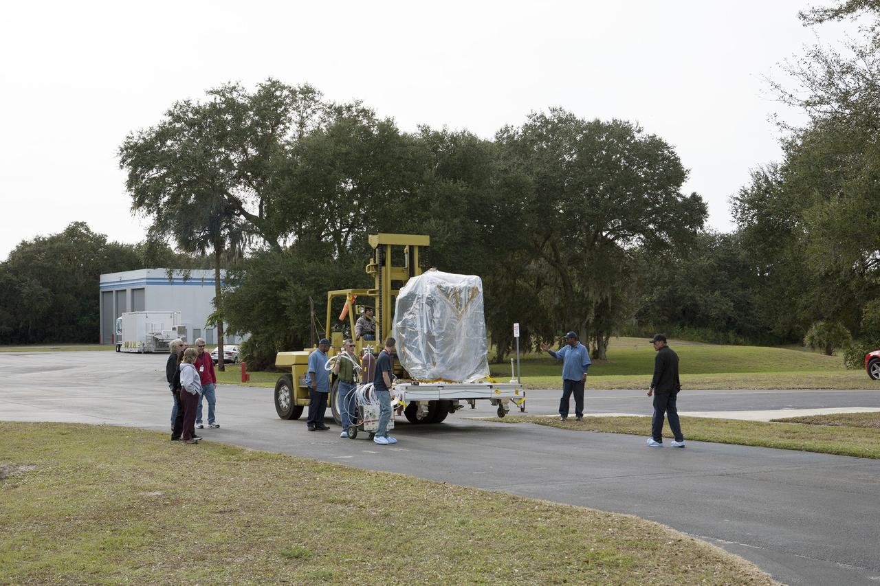 CAPE CANAVERAL, Fla. – Workers transfer NOAA’s Deep Space Climate Observatory spacecraft, or DSCOVR, wrapped in plastic and secured onto a portable work stand, from the airlock of Building 2 to the high bay of Building 1 at the Astrotech payload processing facility in Titusville, Florida, near Kennedy Space Center. DSCOVR is a partnership between NOAA, NASA and the U.S. Air Force. DSCOVR will maintain the nation's real-time solar wind monitoring capabilities which are critical to the accuracy and lead time of NOAA's space weather alerts and forecasts. Launch is currently scheduled for January 2015 aboard a SpaceX Falcon 9 v 1.1 launch vehicle from Cape Canaveral Air Force Station, Florida. To learn more about DSCOVR, visit http://www.nesdis.noaa.gov/DSCOVR. Photo credit: NASA/Kim Shiflett