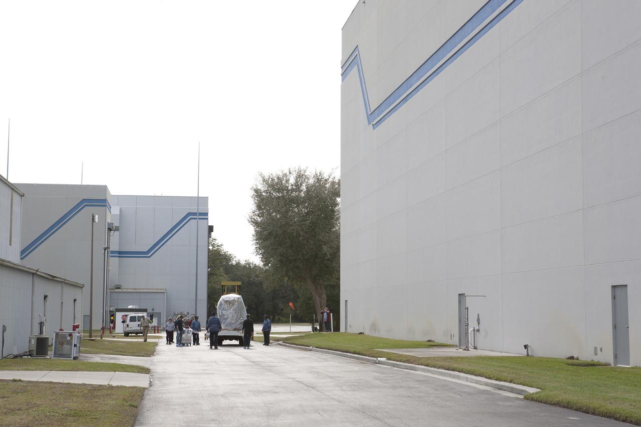 CAPE CANAVERAL, Fla. – Workers monitor NOAA’s Deep Space Climate Observatory spacecraft, or DSCOVR, wrapped in plastic and secured onto a portable work stand, as it travels between the airlock of Building 2 to the high bay of Building 1 at the Astrotech payload processing facility in Titusville, Florida, near Kennedy Space Center.    DSCOVR is a partnership between NOAA, NASA and the U.S. Air Force. DSCOVR will maintain the nation's real-time solar wind monitoring capabilities which are critical to the accuracy and lead time of NOAA's space weather alerts and forecasts. Launch is currently scheduled for January 2015 aboard a SpaceX Falcon 9 v 1.1 launch vehicle from Cape Canaveral Air Force Station, Florida. To learn more about DSCOVR, visit http://www.nesdis.noaa.gov/DSCOVR.  Photo credit: NASA/Kim Shiflett
