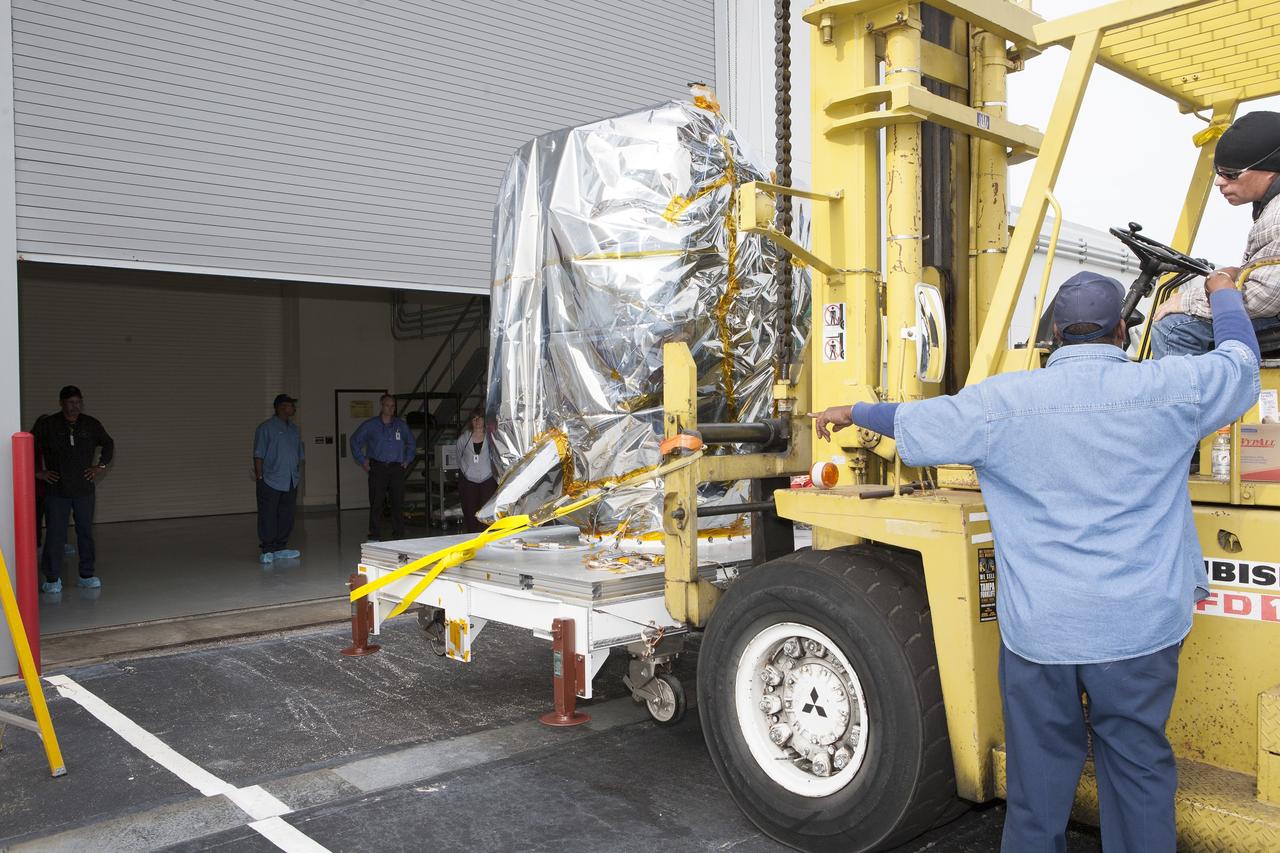CAPE CANAVERAL, Fla. – NOAA’s newly arrived Deep Space Climate Observatory spacecraft, or DSCOVR, wrapped in plastic and secured onto a portable work stand, is delivered to the high bay of Building 1 at the Astrotech payload processing facility in Titusville, Florida, near Kennedy Space Center. DSCOVR is a partnership between NOAA, NASA and the U.S. Air Force. DSCOVR will maintain the nation's real-time solar wind monitoring capabilities which are critical to the accuracy and lead time of NOAA's space weather alerts and forecasts. Launch is currently scheduled for January 2015 aboard a SpaceX Falcon 9 v 1.1 launch vehicle from Cape Canaveral Air Force Station, Florida. To learn more about DSCOVR, visit http://www.nesdis.noaa.gov/DSCOVR. Photo credit: NASA/Kim Shiflett