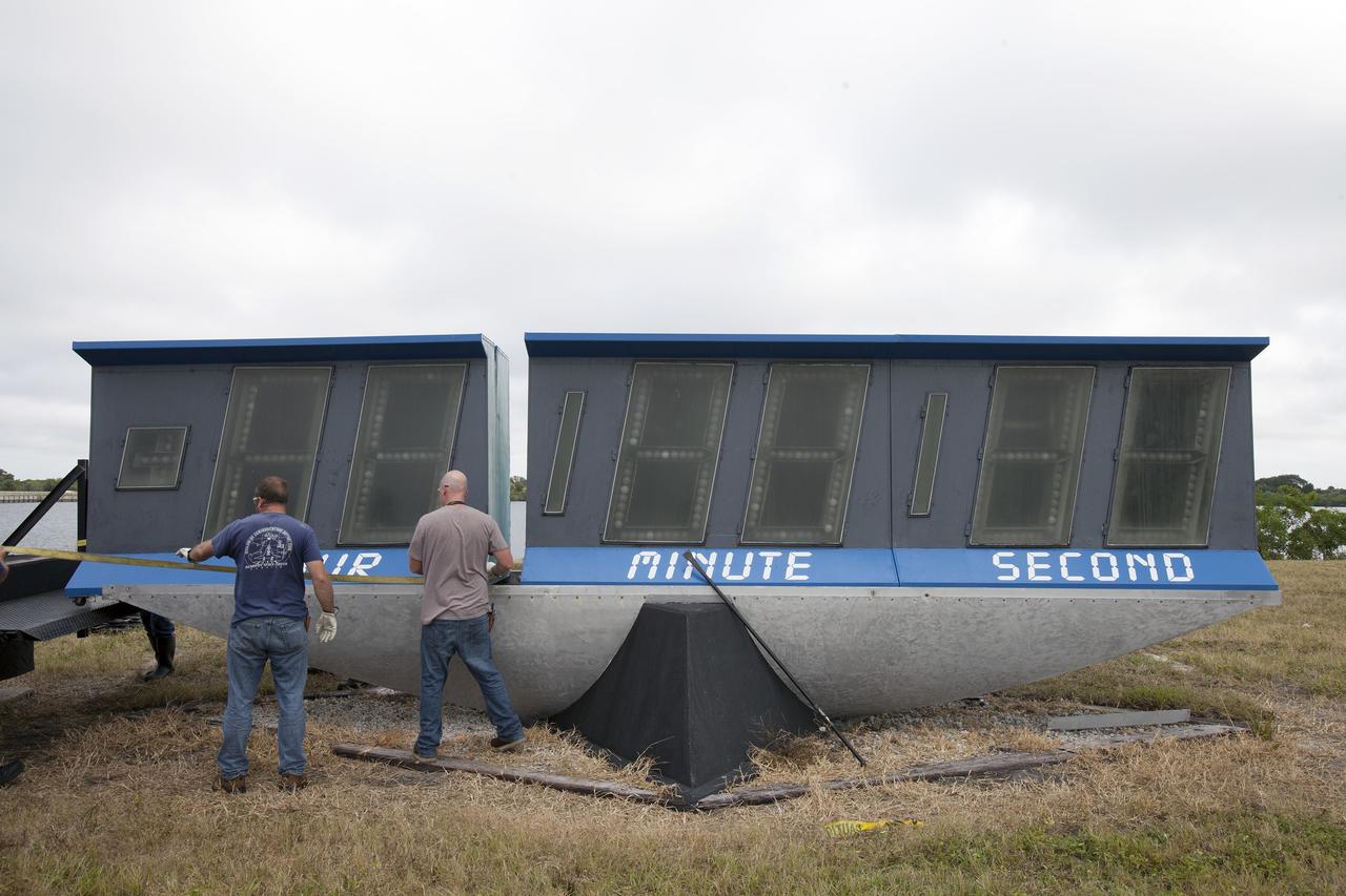 CAPE CANAVERAL, Fla. – At NASA's Kennedy Space Center in Florida, the historic countdown clock at the spaceport's Press Site is disassembled for removal. Kennedy has requested to acquire the countdown clock from the agency’s Artifact Working Group at NASA Headquarters for likely display at the Kennedy Space Center Visitor Complex. A new modern multimedia display soon will be installed, similar to the screens seen at sporting venues, is in the works. The new screen will be nearly 26 feet wide by 7 feet high. The old timepiece was designed by Kennedy engineers and built by Kennedy technicians in 1969. Not including the triangular concrete and aluminum base, the famous landmark is nearly six feet high, 26 feet wide and 3 feet deep. The new display will be similar in size, with the screen being nearly 26 feet wide by seven feet high. For more information on the countdown clock, go to http://go.nasa.gov/10Zku10. Photo credit: NASA/Frankie Martin