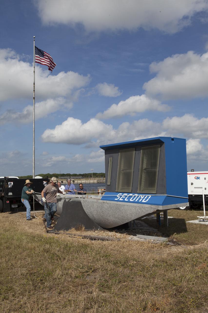 CAPE CANAVERAL, Fla. – At NASA's Kennedy Space Center in Florida, the historic countdown clock at the spaceport's Press Site is disassembled for removal. Kennedy has requested to acquire the countdown clock from the agency’s Artifact Working Group at NASA Headquarters for likely display at the Kennedy Space Center Visitor Complex. A new modern multimedia display soon will be installed, similar to the screens seen at sporting venues, is in the works. The new screen will be nearly 26 feet wide by 7 feet high. The old timepiece was designed by Kennedy engineers and built by Kennedy technicians in 1969. Not including the triangular concrete and aluminum base, the famous landmark is nearly six feet high, 26 feet wide and 3 feet deep. The new display will be similar in size, with the screen being nearly 26 feet wide by seven feet high. For more information on the countdown clock, go to http://go.nasa.gov/10Zku10. Photo credit: NASA/Frankie Martin