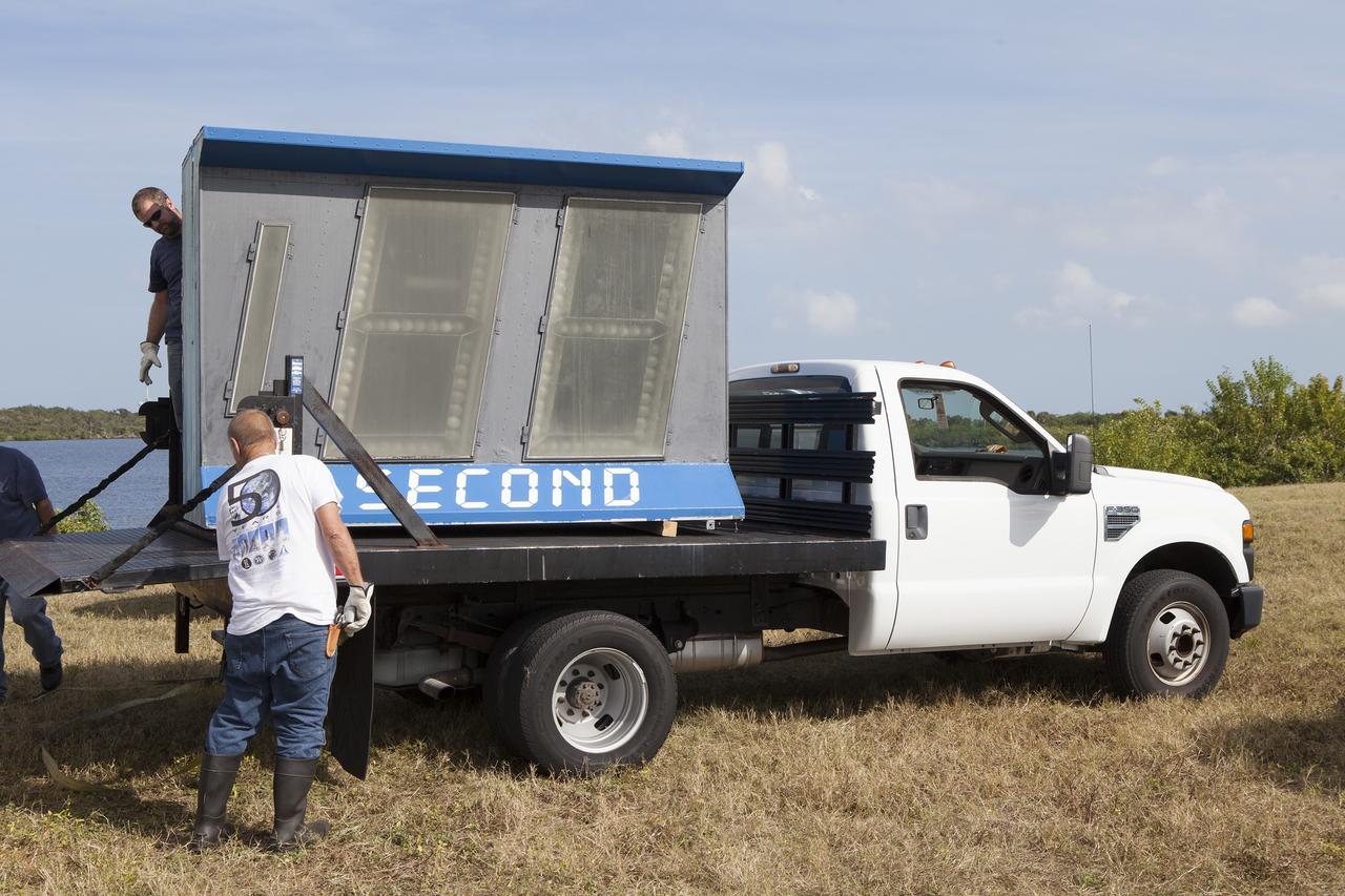 CAPE CANAVERAL, Fla. – At NASA's Kennedy Space Center in Florida, the historic countdown clock at the spaceport's Press Site is disassembled for removal. Kennedy has requested to acquire the countdown clock from the agency’s Artifact Working Group at NASA Headquarters for likely display at the Kennedy Space Center Visitor Complex. A new modern multimedia display soon will be installed, similar to the screens seen at sporting venues, is in the works. The new screen will be nearly 26 feet wide by 7 feet high.     The old timepiece was designed by Kennedy engineers and built by Kennedy technicians in 1969. Not including the triangular concrete and aluminum base, the famous landmark is nearly six feet high, 26 feet wide and 3 feet deep. The new display will be similar in size, with the screen being nearly 26 feet wide by seven feet high. For more information on the countdown clock, go to http://go.nasa.gov/10Zku10. Photo credit: NASA/Frankie Martin