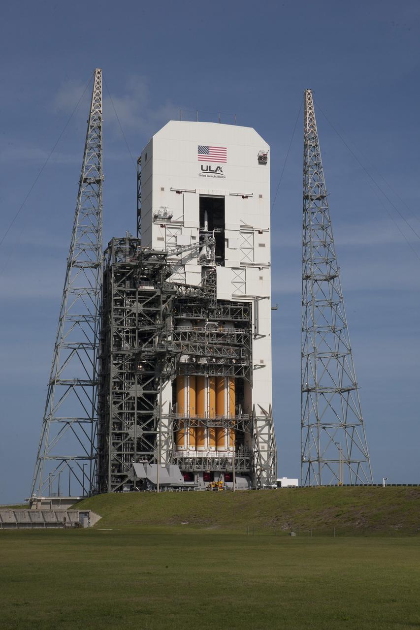 CAPE CANAVERAL, Fla. – With access doors at Space Launch Complex 37 opened, the Orion and Delta IV Heavy stack is visible in its entirety inside the Mobile Service Tower where the vehicle is undergoing launch preparations. Orion will make its first flight test on Dec. 4 with a morning launch atop the United Launch Alliance Delta IV Heavy. The spacecraft will orbit the Earth twice, including one loop that will reach 3,600 miles above Earth. No one will be aboard Orion for this flight test, but the spacecraft is being designed and built to carry astronauts to deep space destinations such as an asteroid. Photo credit: NASA/Kim Shiflett