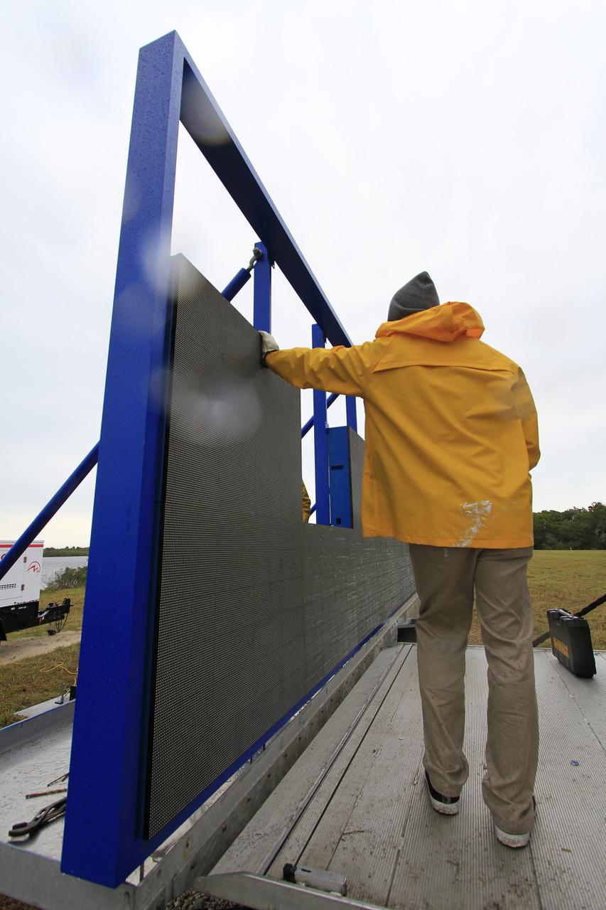CAPE CANAVERAL, Fla. – At NASA's Kennedy Space Center in Florida, work continues to install 24 light emitting diode LED panels in the new countdown clock at the spaceport's Press Site. The modern, multimedia display is similar to the screens seen at sporting venues. The new screen will be nearly 26 feet wide by 7 feet high, a foot taller than the original clock.    The historic countdown clock was designed by Kennedy engineers and built by space center technicians before Apollo 12 in 1969. NASA has requested to acquire the countdown clock from the agency’s Artifact Working Group at the agency's Headquarters for likely display at the Kennedy Space Center Visitor Complex. For more information on the countdown clock, go to http://go.nasa.gov/10Zku10. Photo credit: NASA/Cory Huston