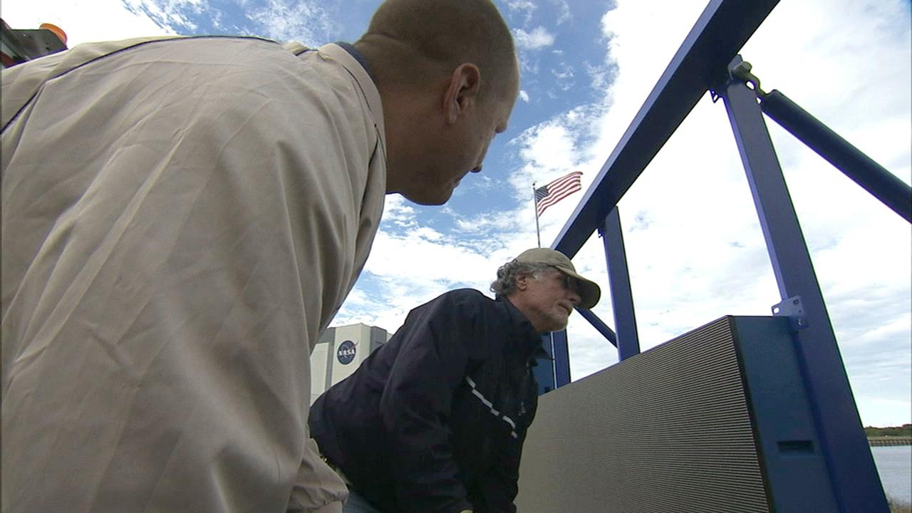 CAPE CANAVERAL, Fla. – At NASA's Kennedy Space Center in Florida, work continues to install 24 light emitting diode LED panels in the new countdown clock at the spaceport's Press Site. The modern, multimedia display is similar to the screens seen at sporting venues. The new screen will be nearly 26 feet wide by 7 feet high, a foot taller than the original clock.    The historic countdown clock was designed by Kennedy engineers and built by space center technicians before Apollo 12 in 1969. NASA has requested to acquire the countdown clock from the agency’s Artifact Working Group at the agency's Headquarters for display at the Kennedy Space Center Visitor Complex. For more information on the countdown clock, go to http://go.nasa.gov/10Zku10. Photo credit: NASA/Ben Smegelsky