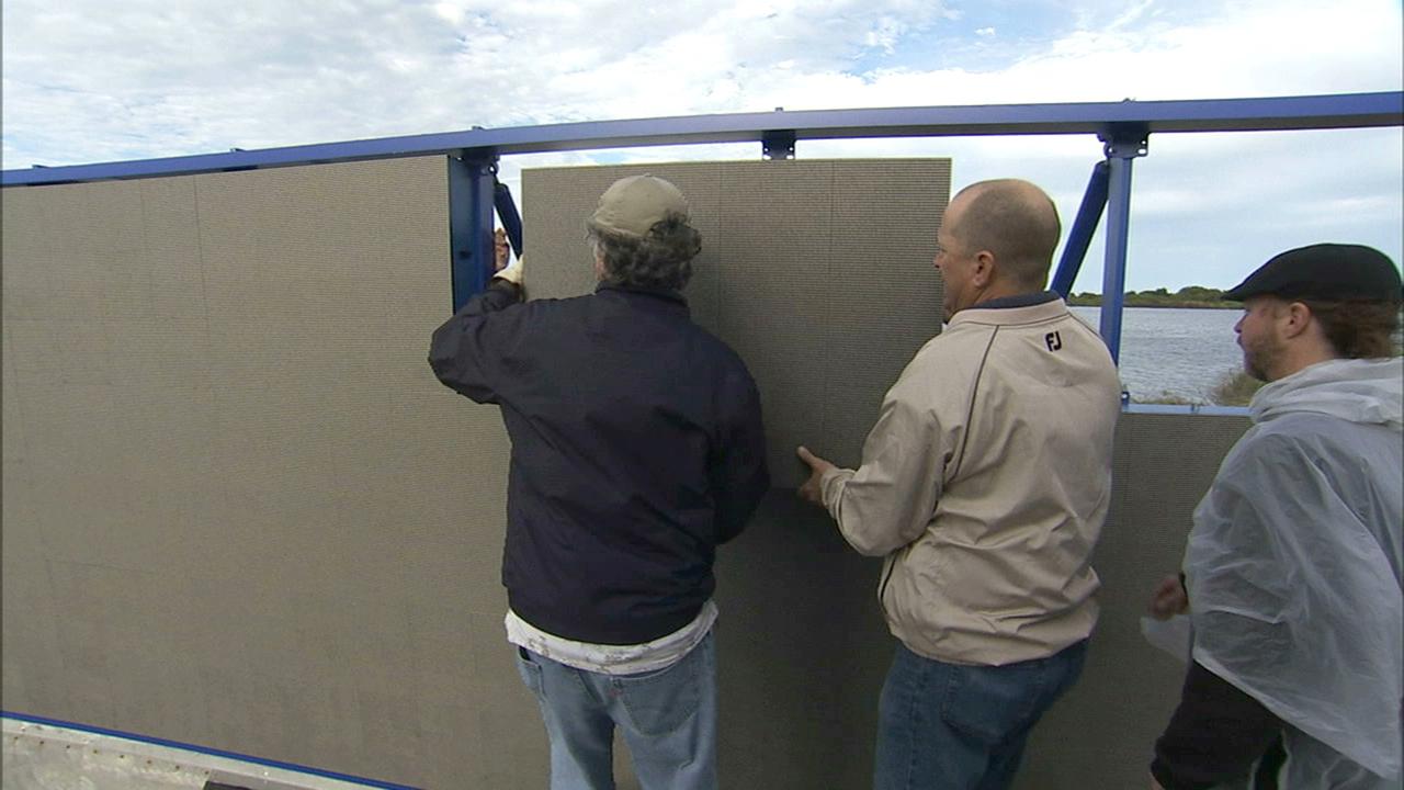 CAPE CANAVERAL, Fla. – At NASA's Kennedy Space Center in Florida, work continues to install 24 light emitting diode LED panels in the new countdown clock at the spaceport's Press Site. The modern, multimedia display is similar to the screens seen at sporting venues. The new screen will be nearly 26 feet wide by 7 feet high, a foot taller than the original clock.    The historic countdown clock was designed by Kennedy engineers and built by space center technicians before Apollo 12 in 1969. NASA has requested to acquire the countdown clock from the agency’s Artifact Working Group at the agency's Headquarters for display at the Kennedy Space Center Visitor Complex. For more information on the countdown clock, go to http://go.nasa.gov/10Zku10. Photo credit: NASA/Ben Smegelsky
