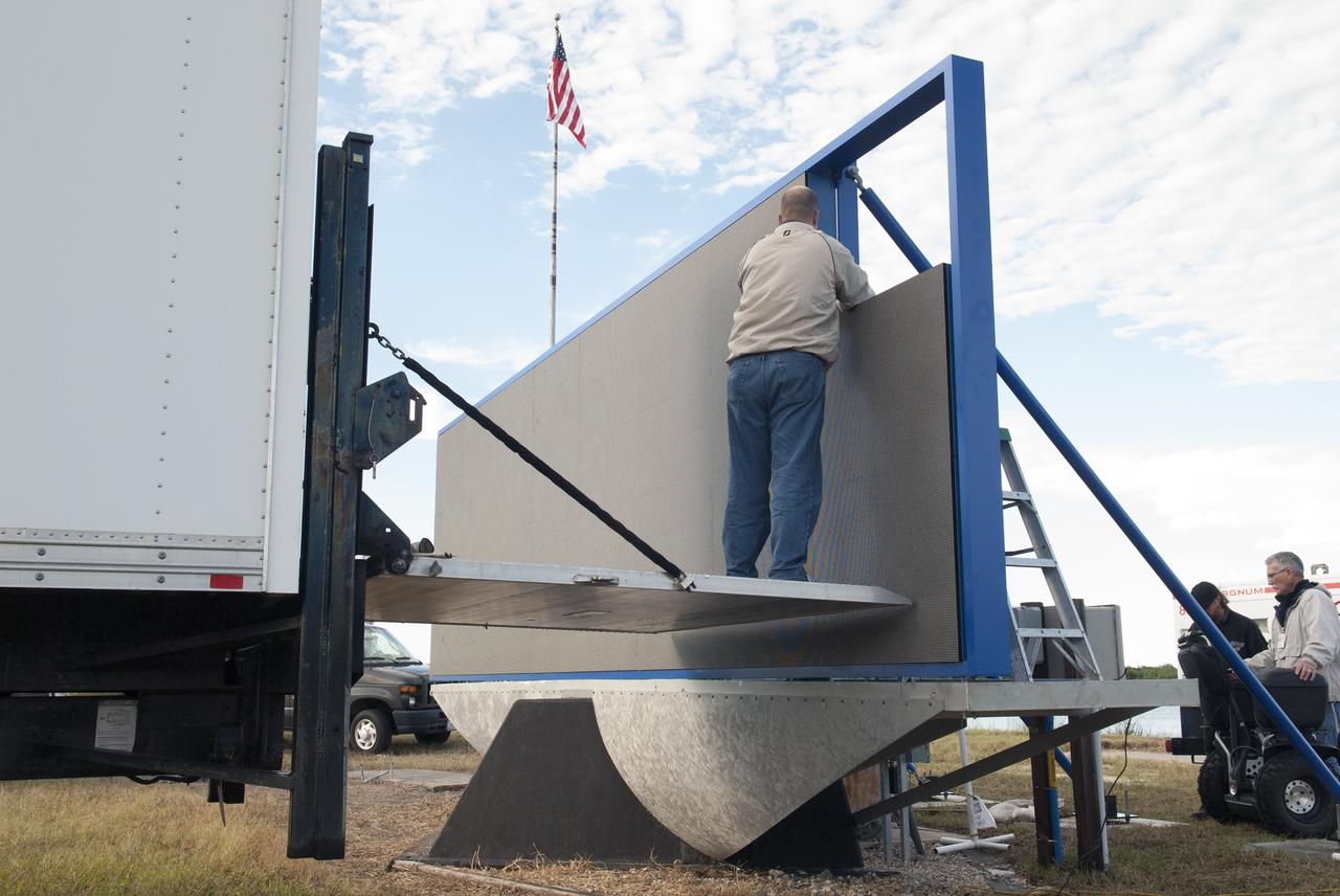 CAPE CANAVERAL, Fla. – At NASA's Kennedy Space Center in Florida, work continues to install 24 light emitting diode LED panels in the new countdown clock at the spaceport's Press Site. The modern, multimedia display is similar to the screens seen at sporting venues. The new screen will be nearly 26 feet wide by 7 feet high, a foot taller than the original clock.    The historic countdown clock was designed by Kennedy engineers and built by space center technicians before Apollo 12 in 1969. NASA has requested to acquire the countdown clock from the agency’s Artifact Working Group at the agency's Headquarters for display at the Kennedy Space Center Visitor Complex. For more information on the countdown clock, go to http://go.nasa.gov/10Zku10. Photo credit: NASA/Jim Grossman