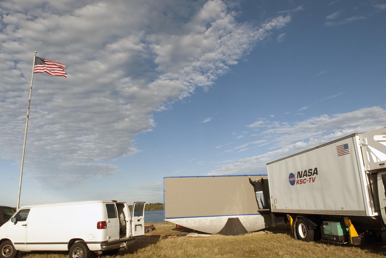 CAPE CANAVERAL, Fla. – At NASA's Kennedy Space Center in Florida, work continues to install 24 light emitting diode LED panels in the new countdown clock at the spaceport's Press Site. The modern, multimedia display is similar to the screens seen at sporting venues. The new screen will be nearly 26 feet wide by 7 feet high, a foot taller than the original clock.    The historic countdown clock was designed by Kennedy engineers and built by space center technicians before Apollo 12 in 1969. NASA has requested to acquire the countdown clock from the agency’s Artifact Working Group at the agency's Headquarters for display at the Kennedy Space Center Visitor Complex. For more information on the countdown clock, go to http://go.nasa.gov/10Zku10. Photo credit: NASA/Jim Grossman