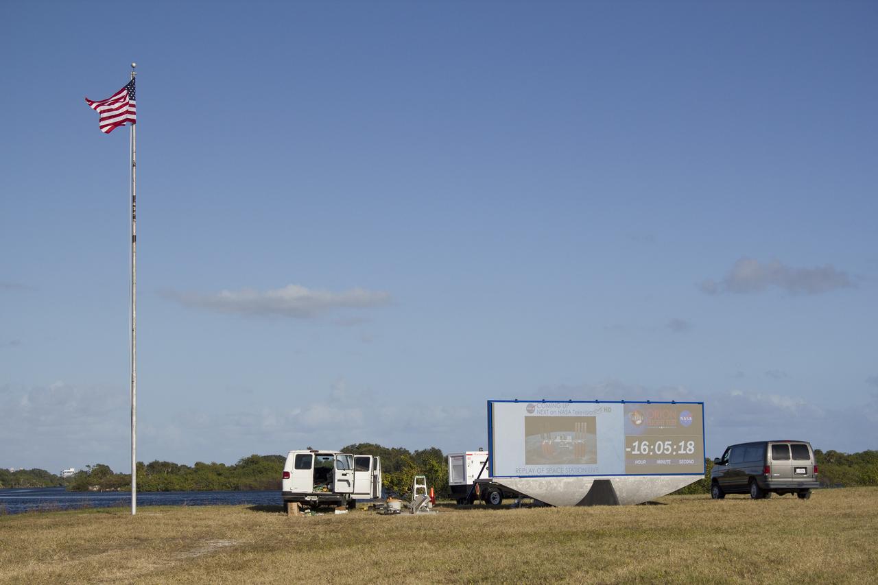 CAPE CANAVERAL, Fla. – At NASA's Kennedy Space Center in Florida, the new countdown clock at the spaceport's Press Site is being tested. The modern, multimedia display is similar to the screens seen at sporting venues. The new screen will be nearly 26 feet wide by 7 feet high, a foot taller than the original clock.    The historic countdown clock was designed by Kennedy engineers and built by space center technicians before Apollo 12 in 1969. NASA has requested to acquire the countdown clock from the agency’s Artifact Working Group at the agency's Headquarters for display at the Kennedy Space Center Visitor Complex. For more information on the countdown clock, go to http://go.nasa.gov/10Zku10. Photo credit: NASA/Frankie Martin