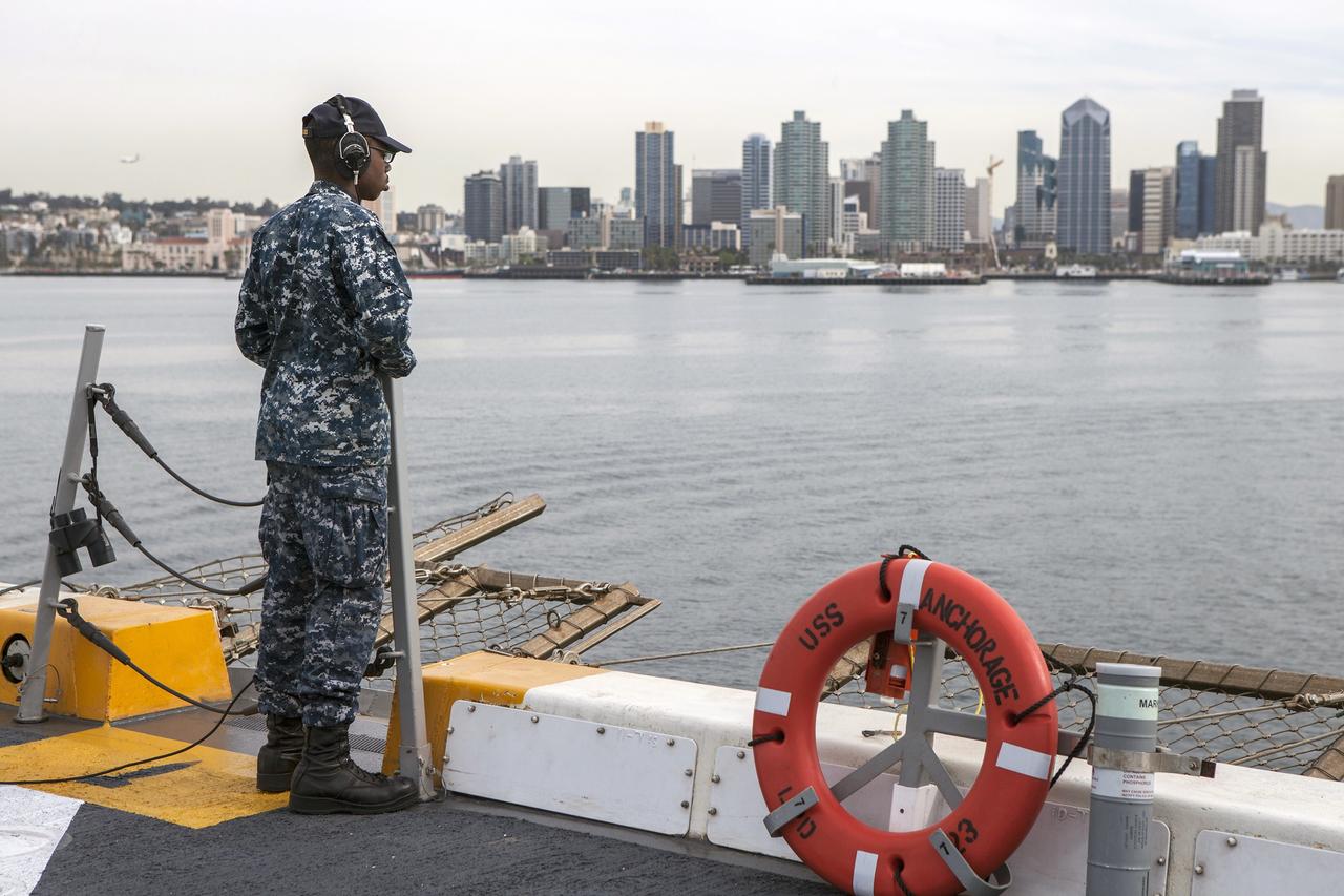 SAN DIEGO, Calif. – U.S. Navy personnel are stationed on the deck of the USS Anchorage as the ship departs Naval Base San Diego in California. NASA and the U.S. Navy are heading out to sea ahead of Orion's flight test to prepare for recovery of the crew module, forward bay cover and parachutes on its return from space and splashdown in the Pacific Ocean. The Ground Systems Development and Operations Program is leading the recovery efforts.    The first unpiloted flight test of Orion is scheduled to launch this week atop a United Launch Alliance Delta IV Heavy rocket. During its two-orbit, 4.5-hour flight, Orion will venture 3,600 miles in altitude and travel nearly 60,000 miles before returning to Earth for a splashdown in the Pacific Ocean. For more information, visit http://www.nasa.gov/orion. Photo credit: NASA/Cory Huston