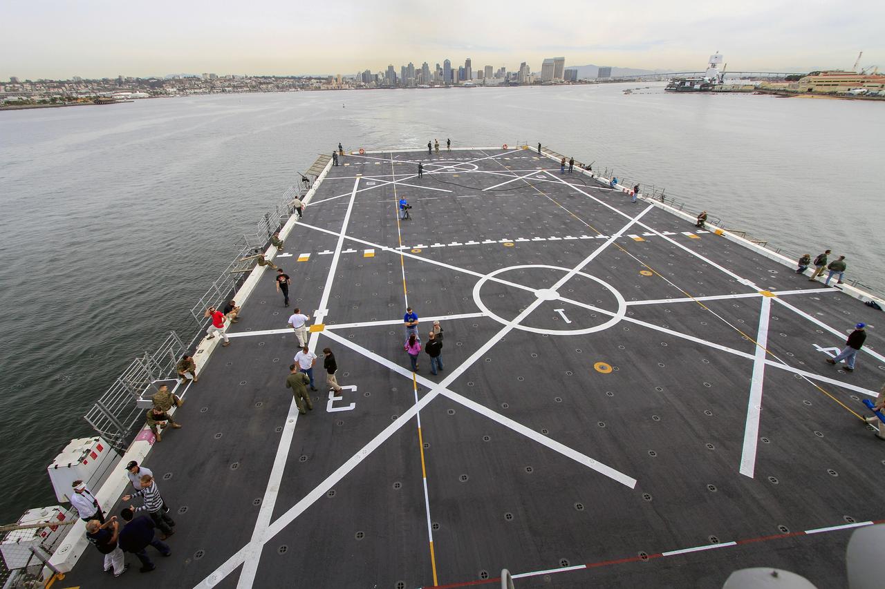 SAN DIEGO, Calif. – NASA and U.S. Navy personnel are on the deck of the USS Anchorage as the ship departs Naval Base San Diego and heads out to sea in the Pacific Ocean.  NASA and the U.S. Navy are making preparations ahead of Orion's flight test for recovery of the crew module, forward bay cover and parachutes on its return from space and splashdown in the Pacific Ocean. The Ground Systems Development and Operations Program is leading the recovery efforts.    The first unpiloted flight test of Orion is scheduled to launch this week atop a United Launch Alliance Delta IV Heavy rocket. During its two-orbit, 4.5-hour flight, Orion will venture 3,600 miles in altitude and travel nearly 60,000 miles before returning to Earth for a splashdown in the Pacific Ocean. For more information, visit http://www.nasa.gov/orion. Photo credit: NASA/Cory Huston