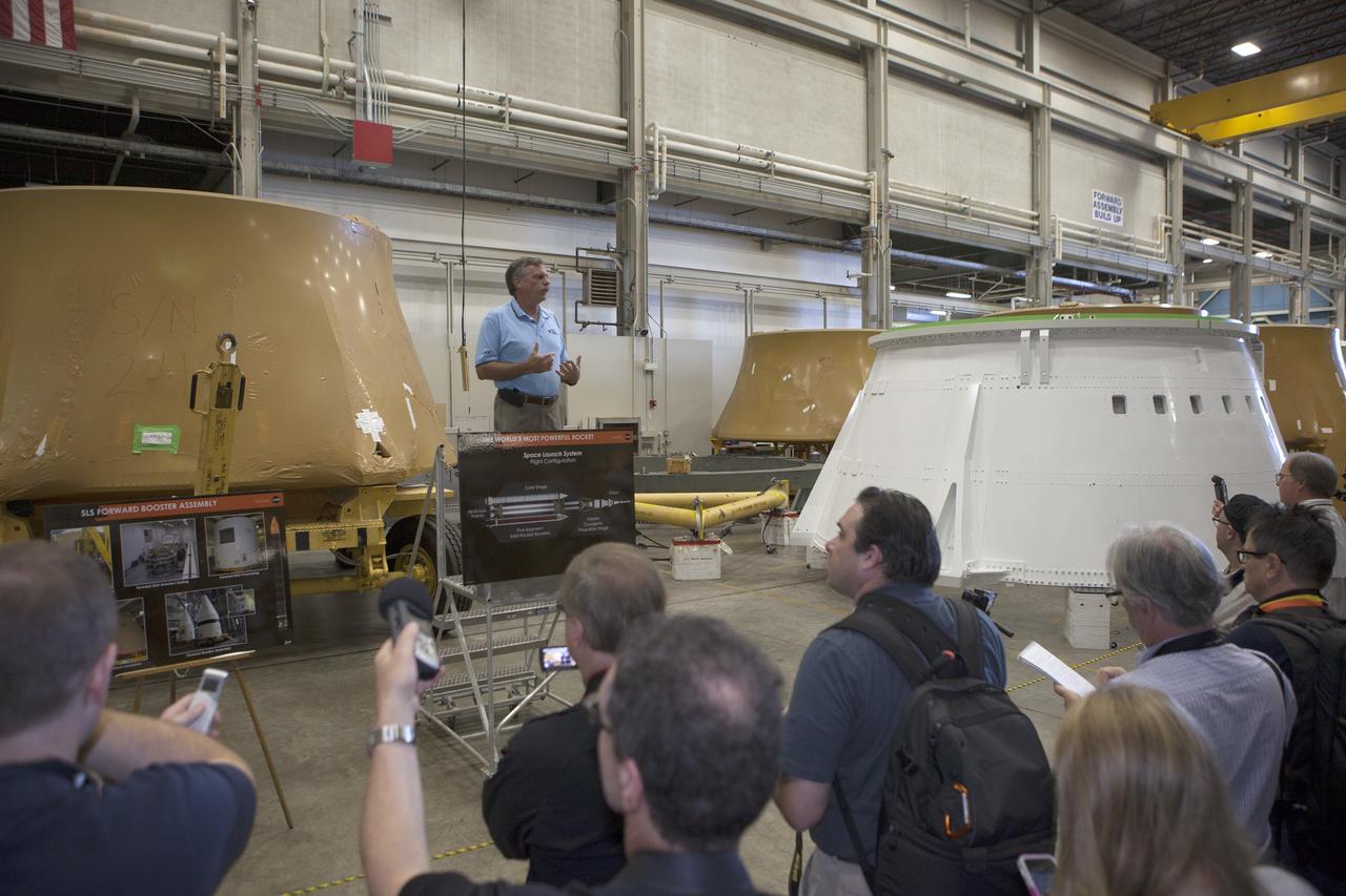 CAPE CANAVERAL, Fla. – At NASA's Kennedy Space Center in Florida, members of the news media are briefed on the agency's Space Launch System SLS Program by Larry Clark, engineering manager for Alliant Techsystems Inc. ATK. The briefing took place in the spaceport's Booster Fabrication Facility BFF. During the Space Shuttle Program, the facility was used for processing forward segments and aft skirts for the solid rocket boosters. The BFF will serve a similar role for the SLS.      Orion is the exploration spacecraft designed to carry astronauts to destinations not yet explored by humans, including an asteroid and Mars. It will have emergency abort capability, sustain the crew during space travel and provide safe re-entry from deep space return velocities. The first unpiloted flight test of Orion is scheduled to launch Dec. 4, 2014 atop a United Launch Alliance Delta IV Heavy rocket, and in 2018 on NASA’s Space Launch System rocket. For more information, visit www.nasa.gov/orion Photo credit: NASA/Kim Shiflett