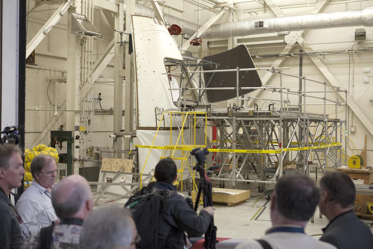 CAPE CANAVERAL, Fla. – At NASA's Kennedy Space Center in Florida, members of the news media tour the spaceport's Vehicle Assembly Building. They were shown an ogive panel which, together with others, cover the Orion spacecraft during launch.      Orion is the exploration spacecraft designed to carry astronauts to destinations not yet explored by humans, including an asteroid and Mars. It will have emergency abort capability, sustain the crew during space travel and provide safe re-entry from deep space return velocities. The first unpiloted flight test of Orion is scheduled to launch Dec. 4, 2014 atop a United Launch Alliance Delta IV Heavy rocket, and in 2018 on NASA’s Space Launch System rocket. For more information, visit www.nasa.gov/orion Photo credit: NASA/Kim Shiflett