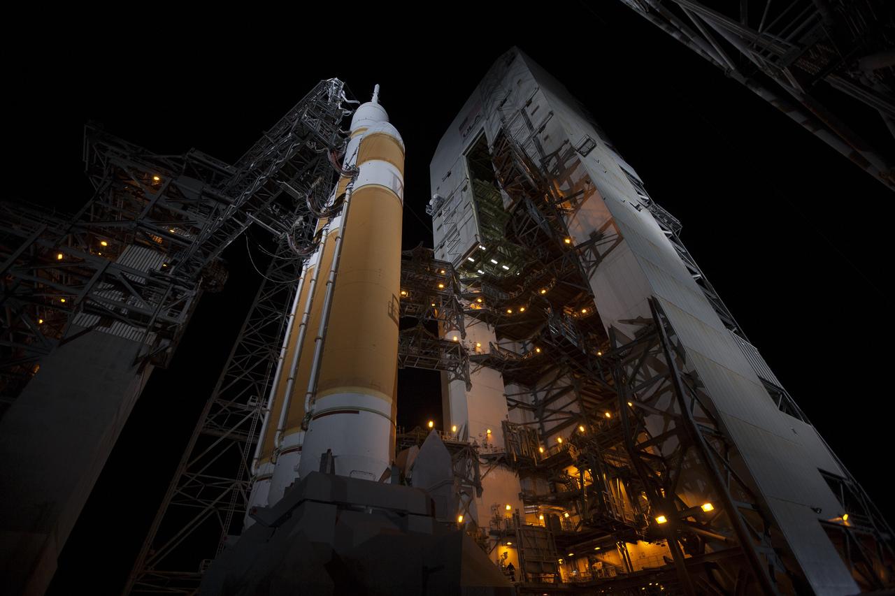 CAPE CANAVERAL, Fla. – The launch gantry is rolled back to reveal NASA's Orion spacecraft mounted atop a United Launch Alliance Delta IV Heavy rocket at Cape Canaveral Air Force Station's Space Launch Complex 37. Orion is NASA’s new spacecraft built to carry humans, designed to allow us to journey to destinations never before visited by humans, including an asteroid and Mars. For more information, visit www.nasa.gov/orion Photo credit: NASA/Kim Shiflett