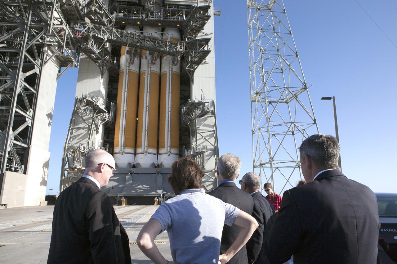 CAPE CANAVERAL, Fla. – At Cape Canaveral Air Force Station's Launch Complex 37, United Launch Alliance CEO Tory Bruno, Johnson Space Center Director Ellen Ochoa and Kennedy Space Center Director Bob Cabana, foreground with backs to the camera, get a close-up view of the United Launch Alliance Delta IV Heavy rocket being prepared to launch NASA's Orion spacecraft on its first flight test. For more information, visit www.nasa.gov/orion. Photo credit: NASA/Kim Shiflett