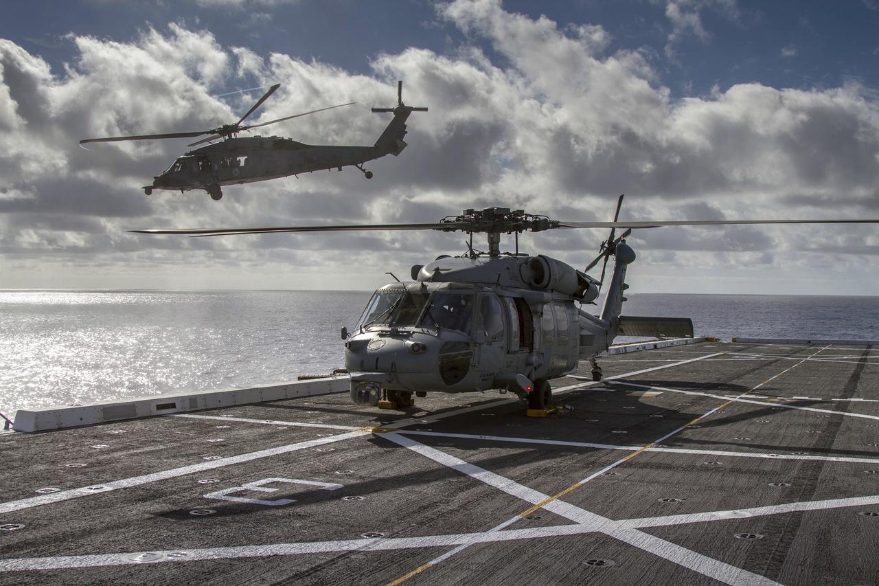 SAN DIEGO, Calif. – On the third day of preparations for recovery of Orion, pilots in two H60-S Seahawk helicopters practice take-off and search from the deck of the USS Anchorage in the Pacific Ocean about 600 miles off the coast of Baja, California. NASA, Lockheed Martin and U.S. Navy personnel are preparing to recover the Orion crew module, forward bay cover and parachutes after the spacecraft's return from space and splashdown in the Pacific Ocean. The Ground Systems Development and Operations Program is leading the recovery efforts.    The first unpiloted flight test of Orion is scheduled to launch Dec. 4 atop a United Launch Alliance Delta IV Heavy rocket. During its two-orbit, 4.5-hour flight, Orion will venture 3,600 miles in altitude and travel nearly 60,000 miles before returning to Earth for a splashdown in the Pacific Ocean. For more information, visit http://www.nasa.gov/orion. Photo credit: NASA/Cory Huston