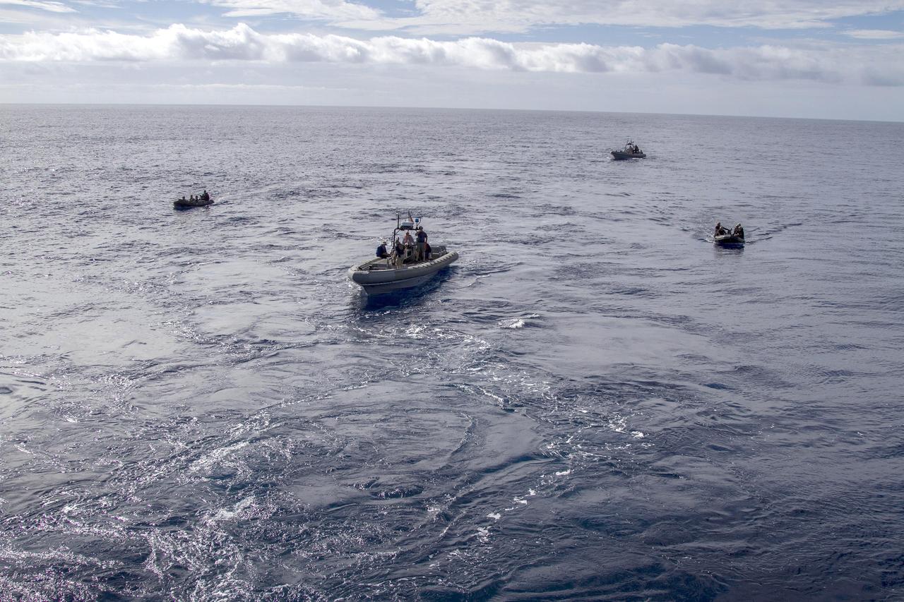 SAN DIEGO, Calif. – On the third day of preparations for recovery of Orion, U.S. Navy divers in two rigid hull inflatable boats and two Zodiac boats practice recovery procedures nearby the USS Anchorage in the Pacific Ocean about 600 miles off the coast of Baja, California. NASA, Lockheed Martin and U.S. Navy personnel are preparing for recovery of the Orion crew module, forward bay cover and parachutes after its return from space and splashdown in the Pacific Ocean. The Ground Systems Development and Operations Program is leading the recovery efforts.    The first unpiloted flight test of Orion is scheduled to launch Dec. 4 atop a United Launch Alliance Delta IV Heavy rocket. During its two-orbit, 4.5-hour flight, Orion will venture 3,600 miles in altitude and travel nearly 60,000 miles before returning to Earth for a splashdown in the Pacific Ocean. For more information, visit http://www.nasa.gov/orion. Photo credit: NASA/Cory Huston