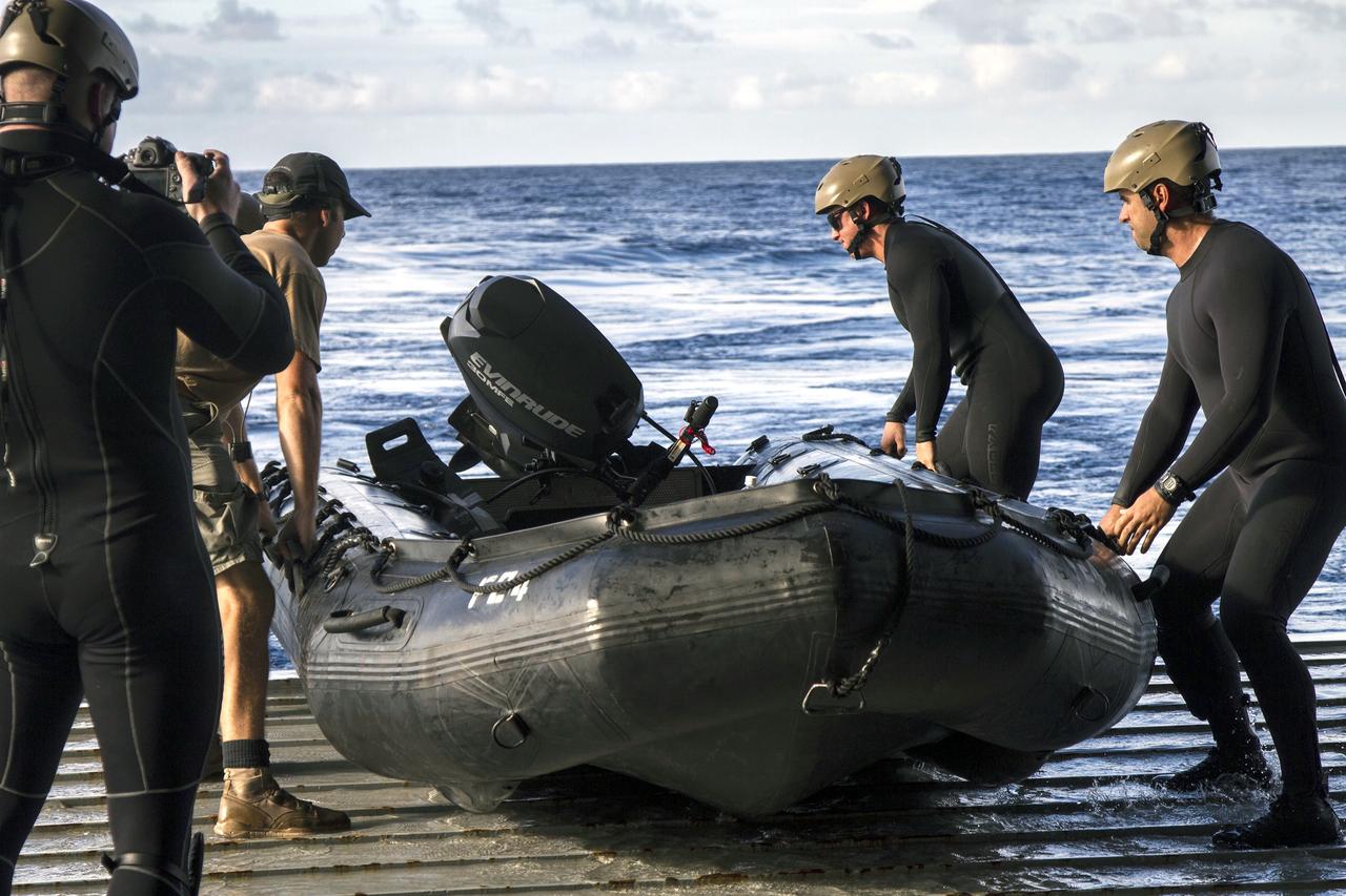 SAN DIEGO, Calif. – On the third day of preparations for recovery of Orion after its splashdown in the Pacific Ocean, U.S. Navy Divers prepare to embark from the well deck of the USS Anchorage in a rigid hull Zodiac boat about 600 miles off the coast of Baja, California. NASA, Lockheed Martin and U.S. Navy personnel are preparing for recovery of the crew module, forward bay cover and parachutes on its return from space and splashdown in the Pacific Ocean. The Ground Systems Development and Operations Program is leading the recovery efforts. The first unpiloted flight test of Orion is scheduled to launch Dec. 4 atop a United Launch Alliance Delta IV Heavy rocket. During its two-orbit, 4.5-hour flight, Orion will venture 3,600 miles in altitude and travel nearly 60,000 miles before returning to Earth for a splashdown in the Pacific Ocean. For more information, visit http://www.nasa.gov/orion. Photo credit: NASA/Cory Huston
