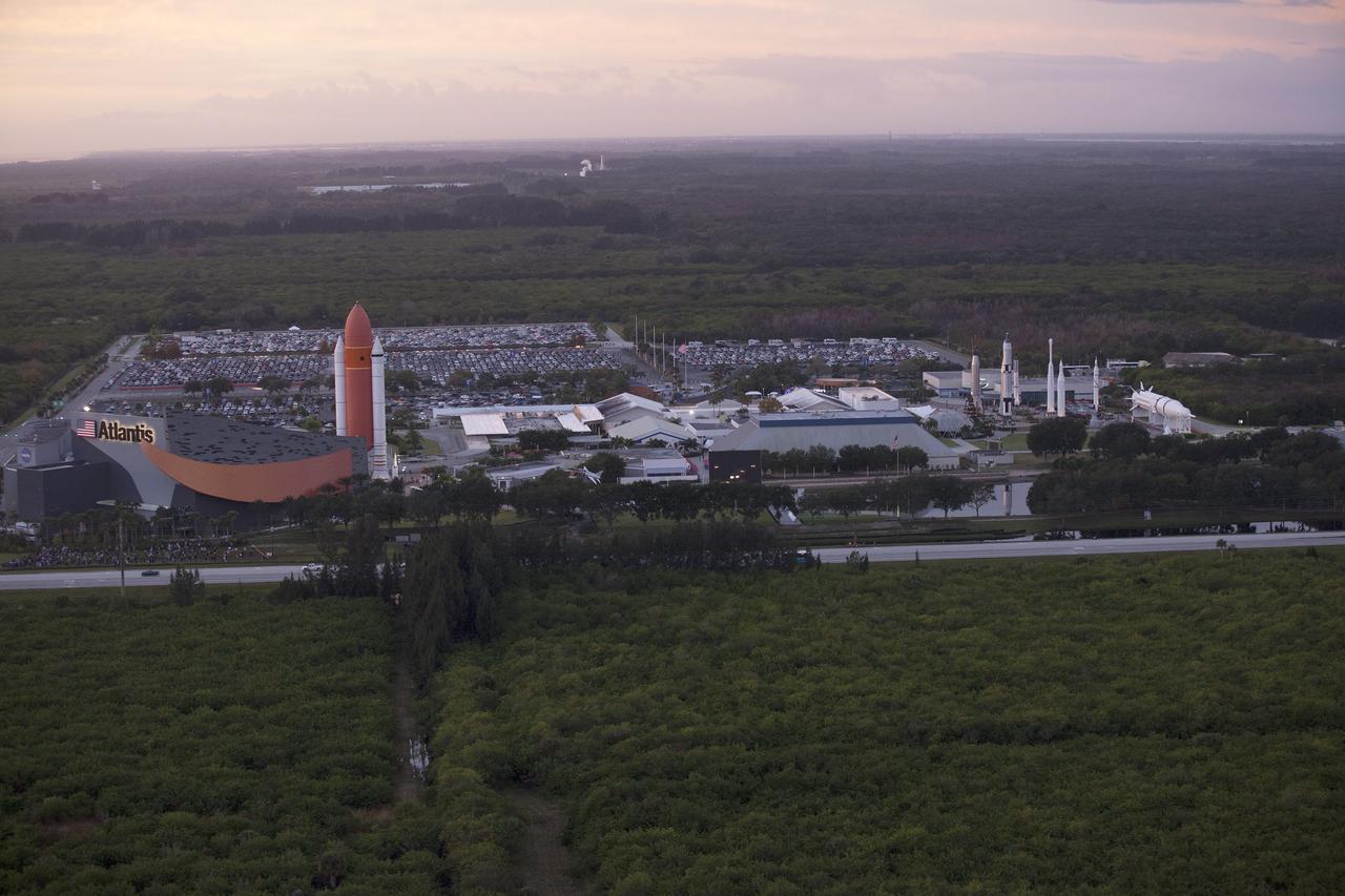 CAPE CANAVERAL, Fla. – This helicopter view of the Kennedy Space Center Visitor Complex shows the thousands of vehicles parked where guests gather to see the launch of the Orion Flight Test. The liftoff was postponed because of an issue related to fill and drain valves on the Delta IV Heavy rocket that teams could not troubleshoot by the time the launch window expired. For more information, visit www.nasa.gov/orion Photo credit: NASA/Kim Shiflett