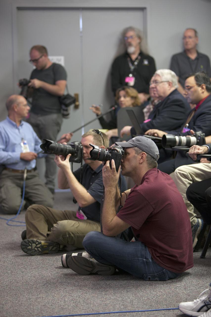 CAPE CANAVERAL, Fla. -- In the Kennedy Space Center’s Press Site auditorium, news media representatives listen and take photographs as NASA and industry leaders talk about the postponement of the Orion Flight Test launch due to an issue related to fill and drain valves on the Delta IV Heavy rocket. For more information, visit www.nasa.gov/orion Photo credit: NASA/Frankie Martin