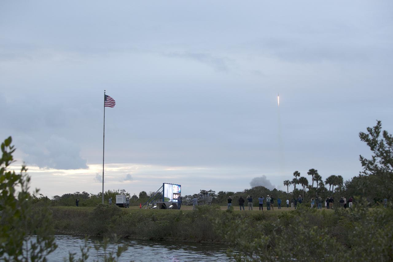 CAPE CANAVERAL, Fla. -- A Delta IV Heavy rocket lifts off from Space Launch Complex 37 at Cape Canaveral Air Force Station in Florida carrying NASA's Orion spacecraft on an unpiloted flight test to Earth orbit. In the foreground is the newly upgraded countdown clock at the spaceport's Press Site. Liftoff was at 7:05 a.m. EST. During the two-orbit, four-and-a-half hour mission, engineers will evaluate the systems critical to crew safety, the launch abort system, the heat shield and the parachute system. Photo credit: NASA/Frankie Martin