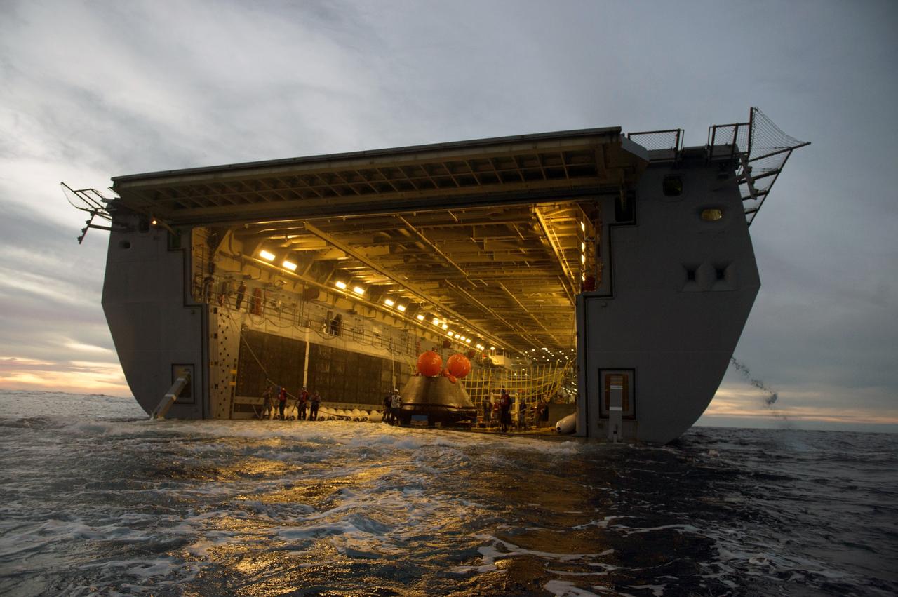 SAN DIEGO, Calif. -- The Orion crew module is recovered after splashdown in the Pacific Ocean about 600 miles off the coast of San Diego, California. NASA, the U.S. Navy and Lockheed Martin coordinated efforts to recover Orion and secure the spacecraft inside the well deck of the USS Anchorage. After lifting off at 7:05 a.m. EST atop a Delta IV Heavy rocket from Space Launch Complex 37 at Cape Canaveral Air Force Station in Florida, NASA's Orion spacecraft completed a two-orbit, four-and-a-half hour mission to test systems critical to crew safety, including the launch abort system, the heat shield and the parachute system. The Ground Systems Development and Operations Program is leading the recovery efforts. For more information, visit www.nasa.gov/orion Photo credit: Courtesy of U.S. Navy