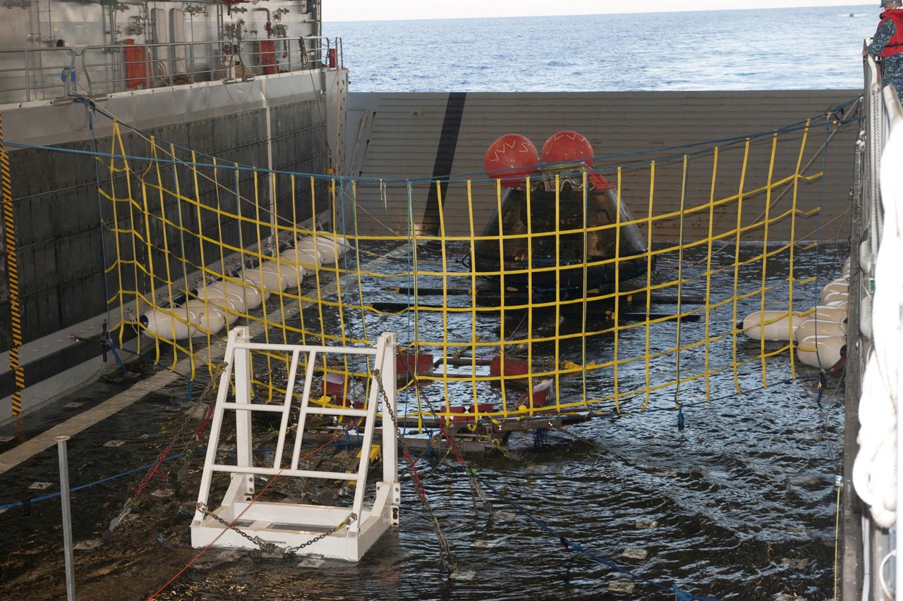 SAN DIEGO, Calif. -- NASA's Orion spacecraft is on rubber bumpers in the flooded well deck of the USS Anchorage in the Pacific Ocean about 600 miles off the coast of San Diego, California. Orion splashed down after its first flight test in Earth orbit. NASA, the U.S. Navy and Lockheed Martin are coordinating efforts to recover Orion and secure the spacecraft in the well deck of the USS Anchorage. Orion completed a two-orbit, four-and-a-half hour mission, to test systems critical to crew safety, including the launch abort system, the heat shield and the parachute system. The Ground Systems Development and Operations Program is leading the recovery efforts. For more information, visit www.nasa.gov/orion Photo credit: NASA/Kenny Allen