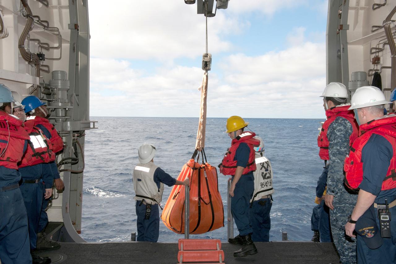 SAN DIEGO, Calif. -- U.S. Navy personnel aboard the USS Anchorage prepare for recovery of NASA's Orion spacecraft from the Pacific Ocean about 600 miles off the coast of San Diego, California. Orion splashed down after its first flight test in Earth orbit. NASA, the U.S. Navy and Lockheed Martin are coordinating efforts to recover Orion and secure the spacecraft in the well deck of the USS Anchorage. Orion completed a two-orbit, four-and-a-half hour mission, to test systems critical to crew safety, including the launch abort system, the heat shield and the parachute system. The Ground Systems Development and Operations Program is leading the recovery efforts. For more information, visit www.nasa.gov/orion Photo credit: NASA/Kenny Allen