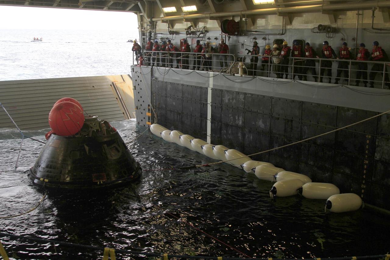 SAN DIEGO, Calif. -- NASA's Orion spacecraft is secured with tether lines inside the flooded well deck of the USS Anchorage in the Pacific Ocean about 600 miles off the coast of San Diego, California. After lifting off at 7:05 a.m. EST atop a Delta IV Heavy rocket from Space Launch Complex 37 at Cape Canaveral Air Force Station in Florida, Orion completed a two-orbit, four-and-a-half hour mission to test systems critical to crew safety, including the launch abort system, the heat shield and the parachute system. NASA, the U.S. Navy and Lockheed Martin coordinated efforts to recover Orion after splashdown. The Ground Systems Development and Operations Program is leading the recovery efforts. For more information, visit www.nasa.gov/orion Photo credit: NASA/Cory Huston