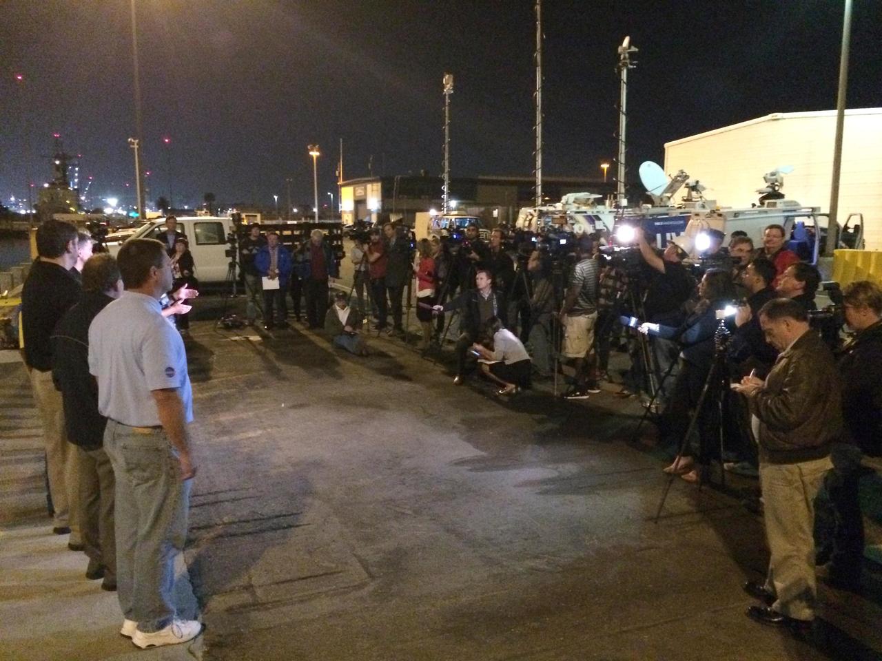 SAN DIEGO, Calif. -- At Naval Base San Diego in California, members of the news media wait to view NASA's Orion spacecraft in the well deck of the USS Anchorage before it is offloaded and prepared for return to Kennedy Space Center in Florida. After lifting off at 7:05 a.m. EST on Dec. 5, atop a Delta IV Heavy rocket from Space Launch Complex 37 at Cape Canaveral Air Force Station in Florida, Orion completed a two-orbit, four-and-a-half hour mission to test systems critical to crew safety, including the launch abort system, the heat shield and the parachute system. NASA, the U.S. Navy and Lockheed Martin coordinated efforts to recover Orion after splashdown in the Pacific Ocean. The Ground Systems Development and Operations Program led the recovery efforts. For more information, visit www.nasa.gov/orion Photo credit: NASA/Amber Philman