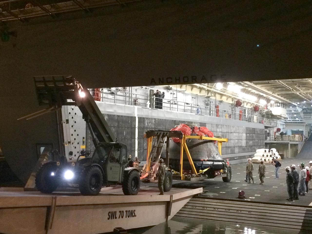 SAN DIEGO, Calif. -- At Naval Base San Diego in California, NASA's Orion spacecraft is being offloaded from the well deck of the USS Anchorage. Orion has been secured in its crew module recovery cradle and will be prepared for return to Kennedy Space Center in Florida. After lifting off at 7:05 a.m. EST on Dec. 5 atop a Delta IV Heavy rocket from Space Launch Complex 37 at Cape Canaveral Air Force Station in Florida, Orion completed a two-orbit, four-and-a-half hour mission to test systems critical to crew safety, including the launch abort system, the heat shield and the parachute system. NASA, the U.S. Navy and Lockheed Martin coordinated efforts to recover Orion after splashdown in the Pacific Ocean. The Ground Systems Development and Operations Program led the recovery efforts. For more information, visit www.nasa.gov/orion Photo credit: NASA/Amber Philman