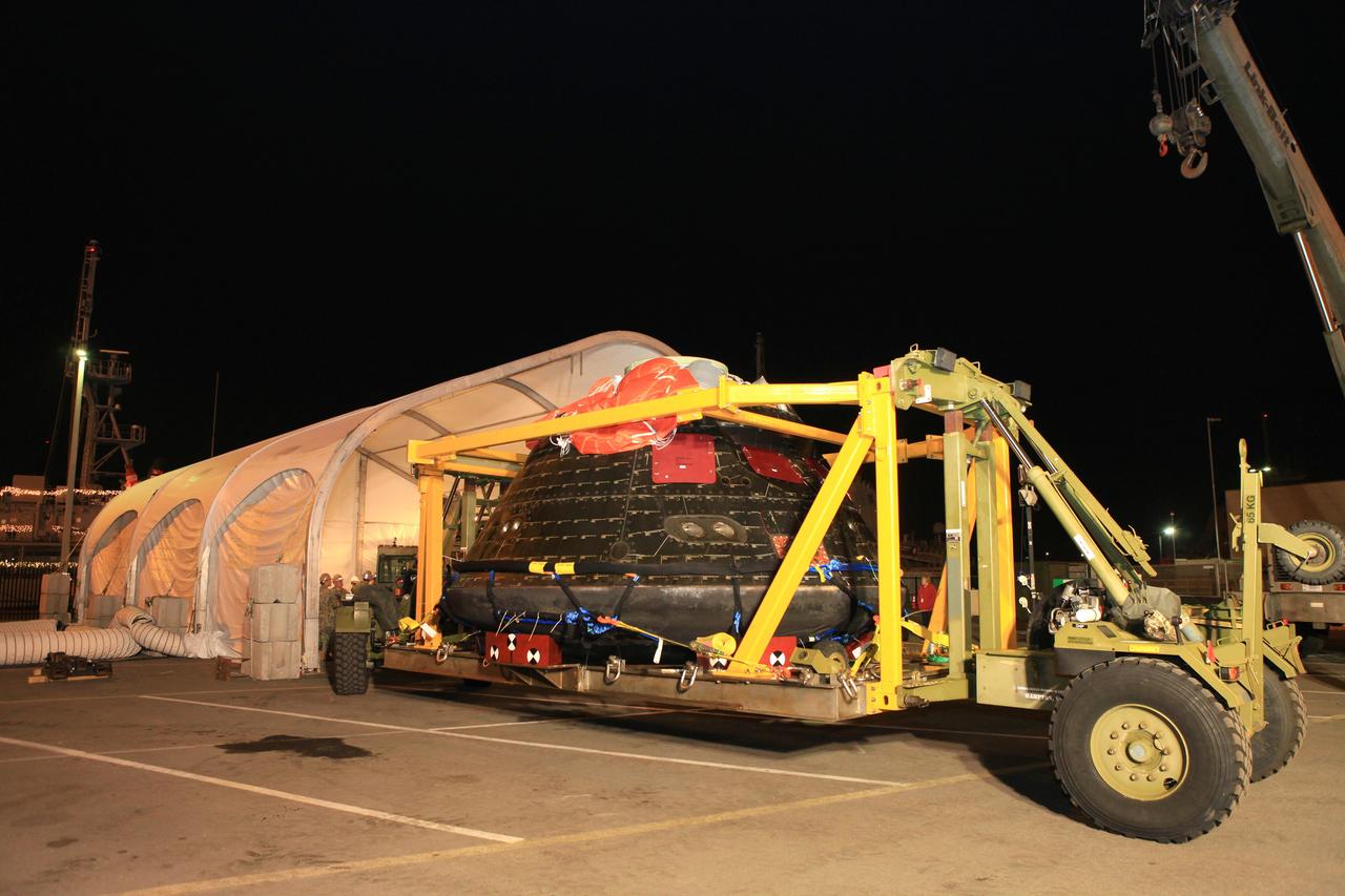 SAN DIEGO, Calif. -- The Orion crew module has been transported to the Mole Pier at Naval Base San Diego in California where it will be prepared for return to NASA's Kennedy Space Center in Florida. Orion was secured on its crew module recovery cradle in the well deck of the USS Anchorage after it was recovered from the Pacific Ocean. After lifting off at 7:05 a.m. EST on Dec. 5, atop a Delta IV Heavy rocket from Space Launch Complex 37 at Cape Canaveral Air Force Station in Florida, Orion completed a two-orbit, four-and-a-half hour mission to test systems critical to crew safety, including the launch abort system, the heat shield and the parachute system. NASA, the U.S. Navy and Lockheed Martin coordinated efforts to recover Orion after splashdown in the Pacific Ocean. The Ground Systems Development and Operations Program led the recovery efforts. For more information, visit www.nasa.gov/orion Photo credit: NASA/Cory Huston