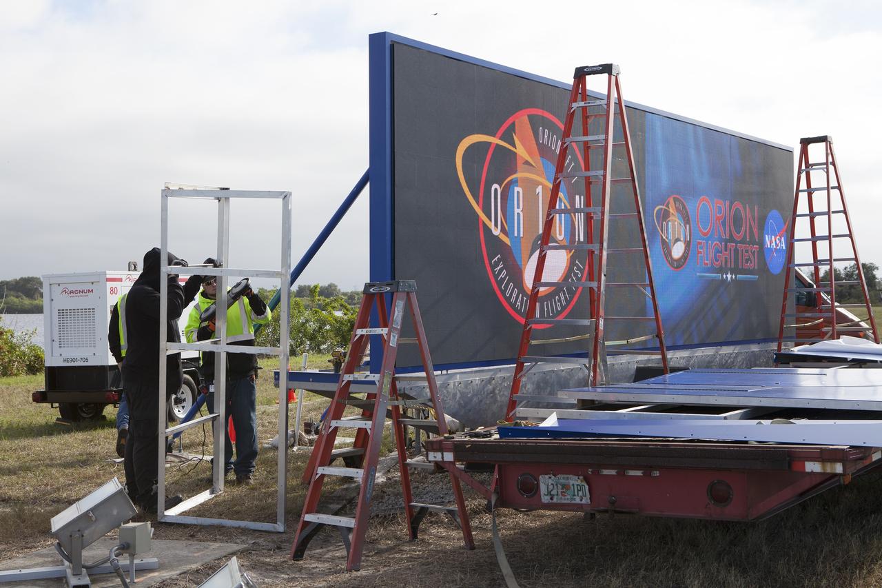 CAPE CANAVERAL, Fla. – At NASA's Kennedy Space Center in Florida, a shade is placed around the new countdown clock at the spaceport's Press Site. The modern, multimedia display is similar to the screens seen at sporting venues. The new screen is nearly 26 feet wide by 7 feet high, a foot taller than the original clock.    The historic countdown clock was designed by Kennedy engineers and built by space center technicians before Apollo 12 in 1969. NASA has acquired the countdown clock from the agency’s Artifact Working Group at the agency's Headquarters for display at the Kennedy Space Center Visitor Complex. For more information on the countdown clock, go to http://go.nasa.gov/10Zku10 Photo credit: NASA/Frankie Martin