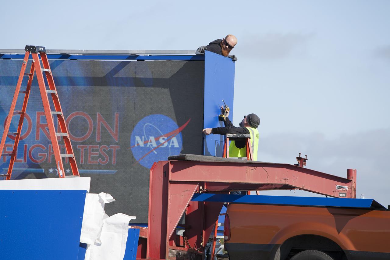 CAPE CANAVERAL, Fla. – At NASA's Kennedy Space Center in Florida, a shade is placed around the new countdown clock at the spaceport's Press Site. The modern, multimedia display is similar to the screens seen at sporting venues. The new screen is nearly 26 feet wide by 7 feet high, a foot taller than the original clock.    The historic countdown clock was designed by Kennedy engineers and built by space center technicians before Apollo 12 in 1969. NASA has acquired the countdown clock from the agency’s Artifact Working Group at the agency's Headquarters for display at the Kennedy Space Center Visitor Complex. For more information on the countdown clock, go to http://go.nasa.gov/10Zku10 Photo credit: NASA/Frankie Martin
