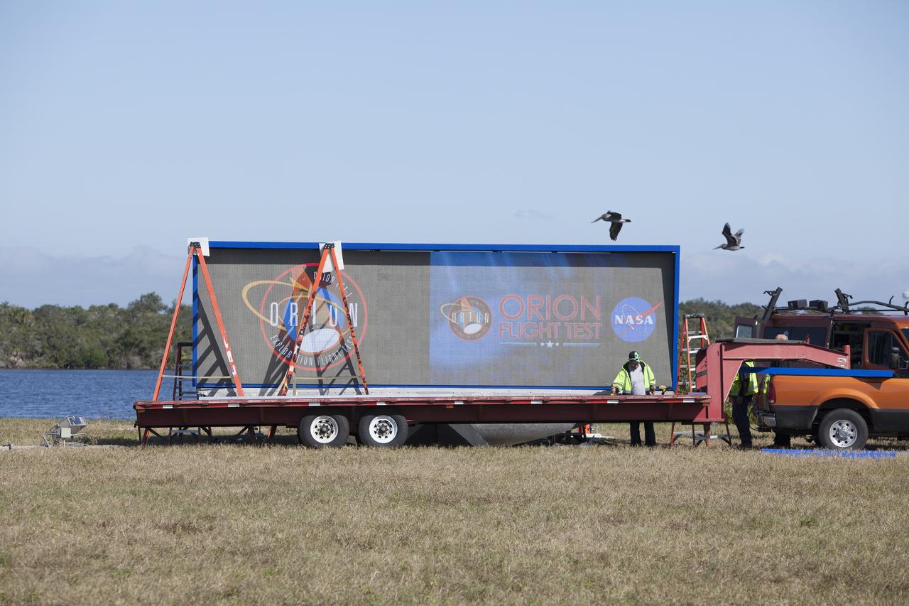 CAPE CANAVERAL, Fla. – At NASA's Kennedy Space Center in Florida, a shade is placed around the new countdown clock at the spaceport's Press Site. The modern, multimedia display is similar to the screens seen at sporting venues. The new screen is nearly 26 feet wide by 7 feet high, a foot taller than the original clock.    The historic countdown clock was designed by Kennedy engineers and built by space center technicians before Apollo 12 in 1969. NASA has acquired the countdown clock from the agency’s Artifact Working Group at the agency's Headquarters for display at the Kennedy Space Center Visitor Complex. For more information on the countdown clock, go to http://go.nasa.gov/10Zku10 Photo credit: NASA/Frankie Martin
