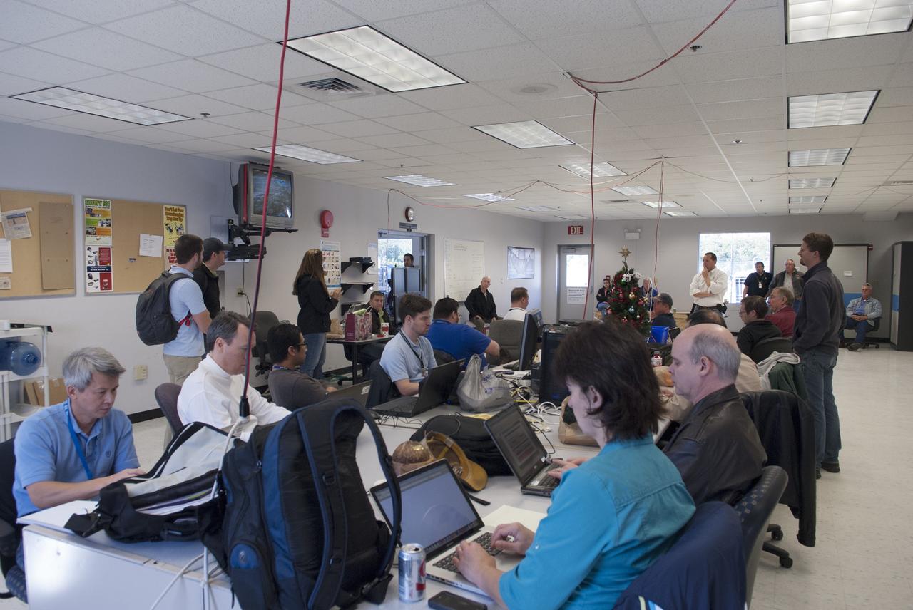 CAPE CANAVERAL, Fla. – Engineers and controllers in a mobile control room prepare for flight number 15 of NASA's Project Morpheus prototype lander at the north end of the Shuttle Landing Facility, or SLF, at NASA’s Kennedy Space Center in Florida. The lander will take off from the ground over a flame trench and use its autonomous landing and hazard avoidance technology, or ALHAT sensors, to survey the hazard field to determine safe landing sites. Project Morpheus tests NASA’s ALHAT and an engine that runs on liquid oxygen and methane, which are green propellants. These new capabilities could be used in future efforts to deliver cargo to planetary surfaces. Project Morpheus is being managed under the Advanced Exploration Systems, or AES, Division in NASA’s Human Exploration and Operations Mission Directorate. For more information on Project Morpheus, visit http://morpheuslander.jsc.nasa.gov/.  Photo credit: NASA/Jim Grossmann