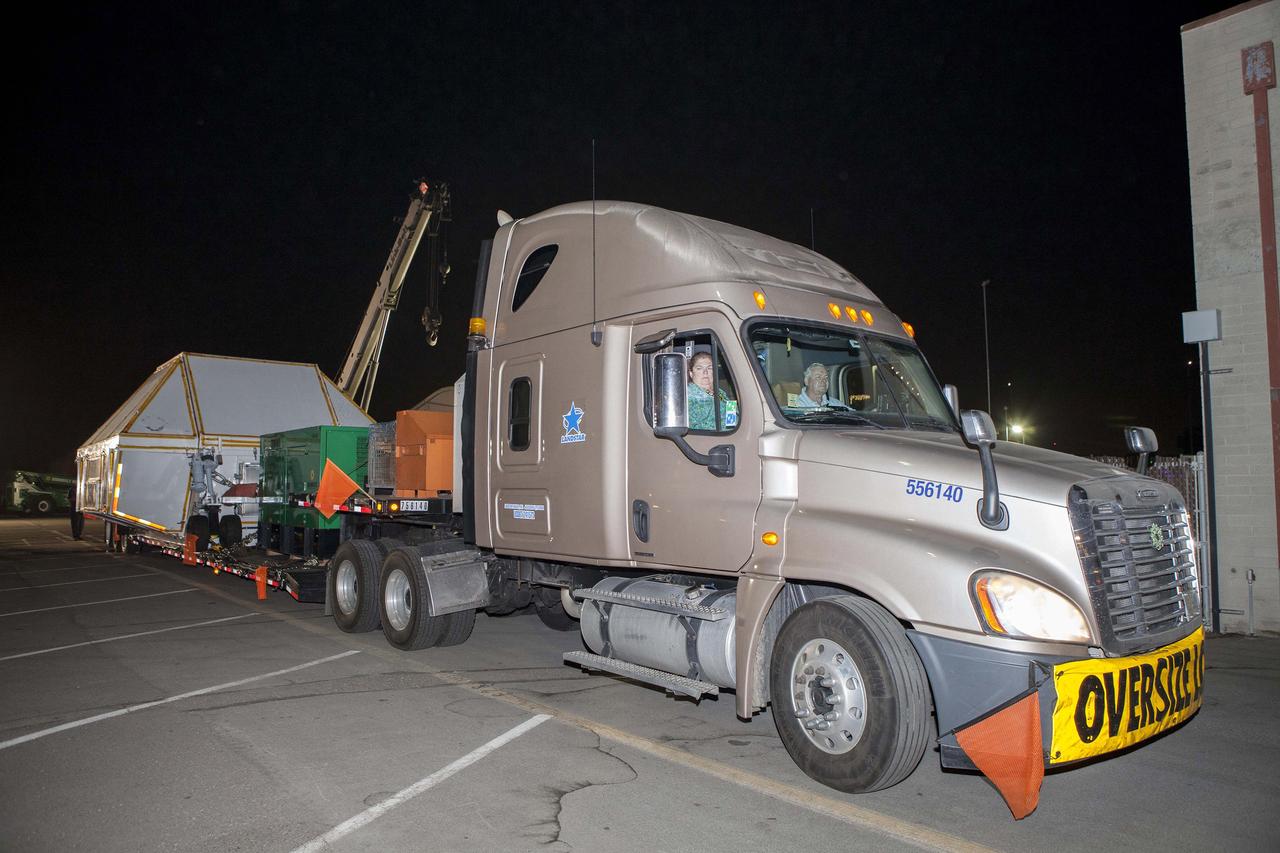 SAN DIEGO, Calif. -- Drivers in a flatbed truck begin the overland trek back to NASA's Kennedy Space Center in Florida, carrying the Orion crew module secured inside the crew module transportation fixture. The truck is leaving the Mole Pier at Naval Base San Diego in California. Orion was recovered from the Pacific Ocean after completing a two-orbit, four-and-a-half hour mission Dec. 5 to test systems critical to crew safety, including the launch abort system, the heat shield and the parachute system. NASA, the U.S. Navy and Lockheed Martin coordinated efforts to recover Orion. The Ground Systems Development and Operations Program led the recovery, offload and pre-transportation efforts. For more information, visit www.nasa.gov/orion Photo credit: NASA/Cory Huston
