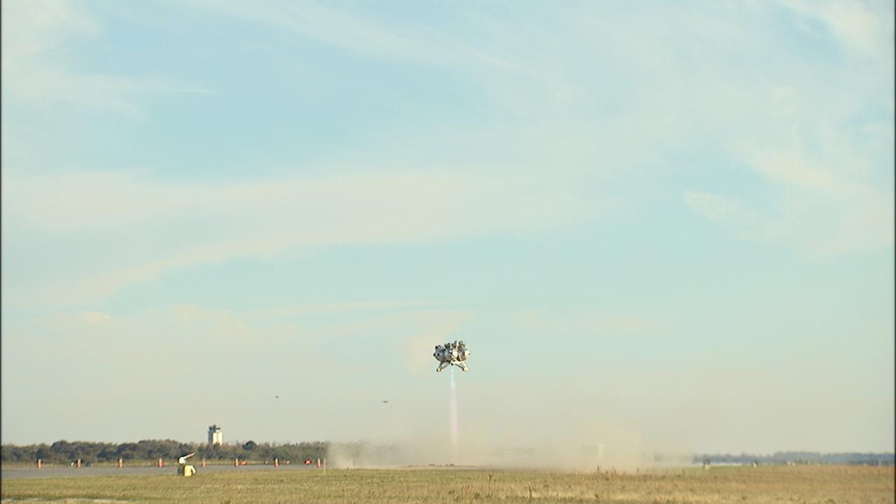 CAPE CANAVERAL, Fla. – NASA’s Project Morpheus prototype lander soars 800 feet above the north end of the Shuttle Landing Facility at Kennedy Space Center in Florida on free flight test No. 15 at. During the 97-second test, onboard autonomous landing and hazard avoidance technology sensors, or ALHAT, surveyed the hazard field for safe landing sites, then guided the lander forward and downward to a successful landing. For more information on Morpheus, visit: http://www.morpheuslander.jsc.nasa.gov. Photo credit: NASA
