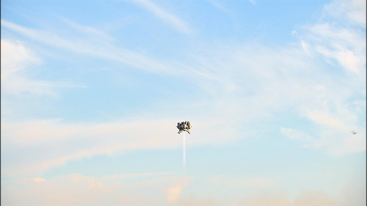 CAPE CANAVERAL, Fla. – NASA’s Project Morpheus prototype lander soars 800 feet above the north end of the Shuttle Landing Facility at Kennedy Space Center in Florida on free flight test No. 15 at. During the 97-second test, onboard autonomous landing and hazard avoidance technology sensors, or ALHAT, surveyed the hazard field for safe landing sites, then guided the lander forward and downward to a successful landing. For more information on Morpheus, visit: http://www.morpheuslander.jsc.nasa.gov. Photo credit: NASA