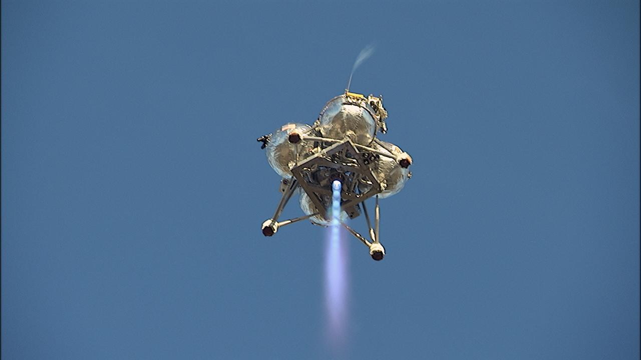 CAPE CANAVERAL, Fla. – NASA’s Project Morpheus prototype lander soars overhead during free flight test No. 15 at the north end of the Shuttle Landing Facility at Kennedy Space Center in Florida. During the 97-second test, onboard autonomous landing and hazard avoidance technology sensors, or ALHAT, surveyed the hazard field for safe landing sites, then guided the lander forward and downward to a successful landing. For more information on Morpheus, visit: http://www.morpheuslander.jsc.nasa.gov. Photo credit: NASA