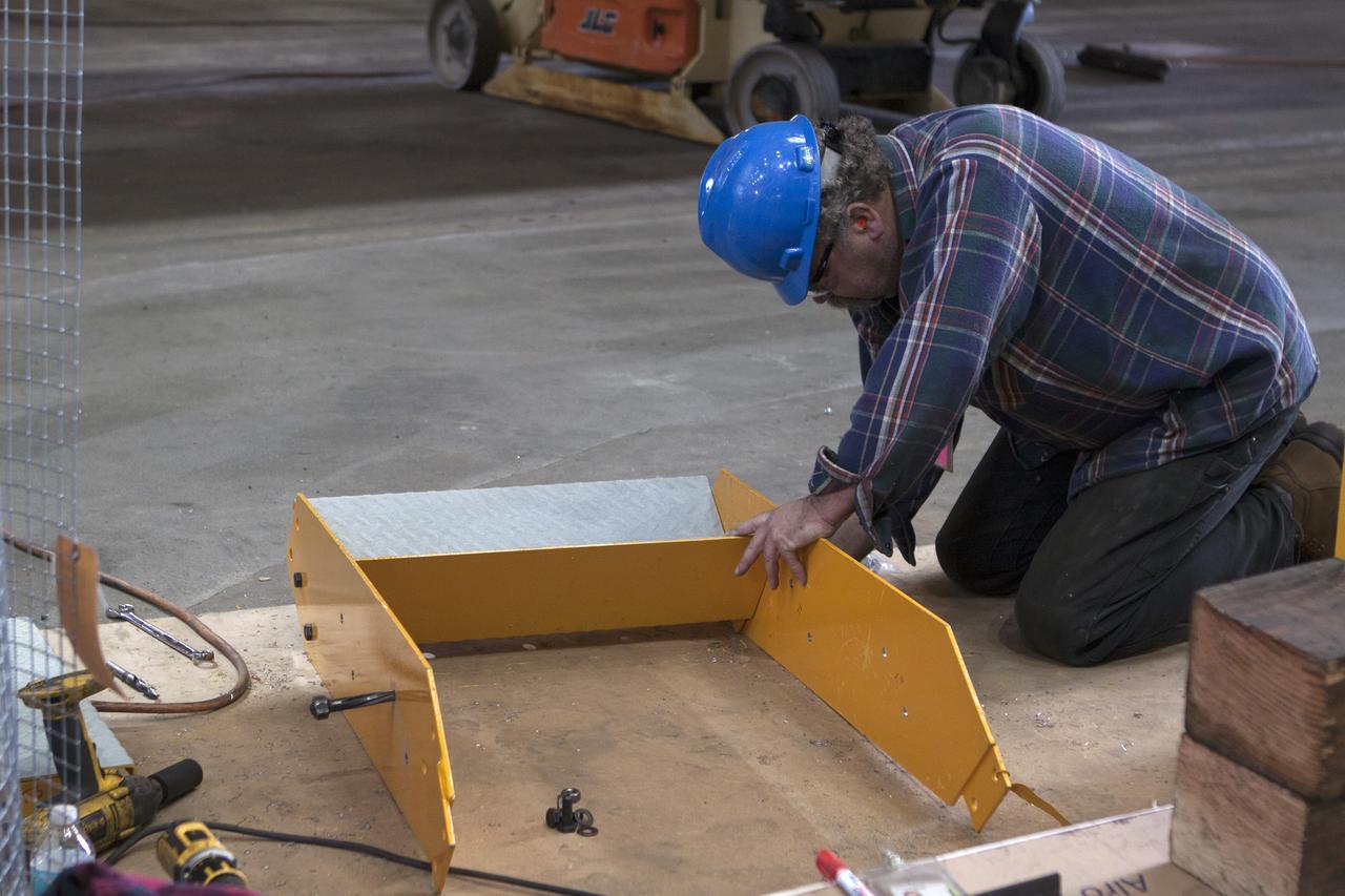 CAPE CANAVERAL, Fla. – Inside the Vehicle Assembly Building at NASA's Kennedy Space Center in Florida, a construction worker continues with refurbishment and upgrades to parts of the 175-ton crane on the ground floor of the transfer aisle. The crane's 45-year-old controls are being upgraded to improve reliability, precision and safety. The Ground Systems Development and Operations Program is overseeing upgrades and modifications to the crane so that it can support lifting needs for NASA and other exploration vehicles, including the agency's Space Launch System and Orion spacecraft. Photo credit: NASA/Kim Shiflett
