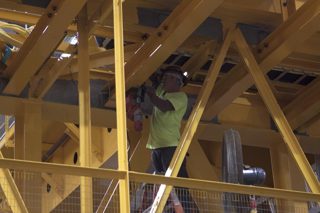 CAPE CANAVERAL, Fla. – Inside the Vehicle Assembly Building at NASA's Kennedy Space Center in Florida, a construction worker continues with refurbishment and upgrades to the 175-ton crane on the ground floor of the transfer aisle. The crane's 45-year-old controls are being upgraded to improve reliability, precision and safety. The Ground Systems Development and Operations Program is overseeing upgrades and modifications to the crane so that it can support lifting needs for NASA and other exploration vehicles, including the agency's Space Launch System and Orion spacecraft. Photo credit: NASA/Kim Shiflett