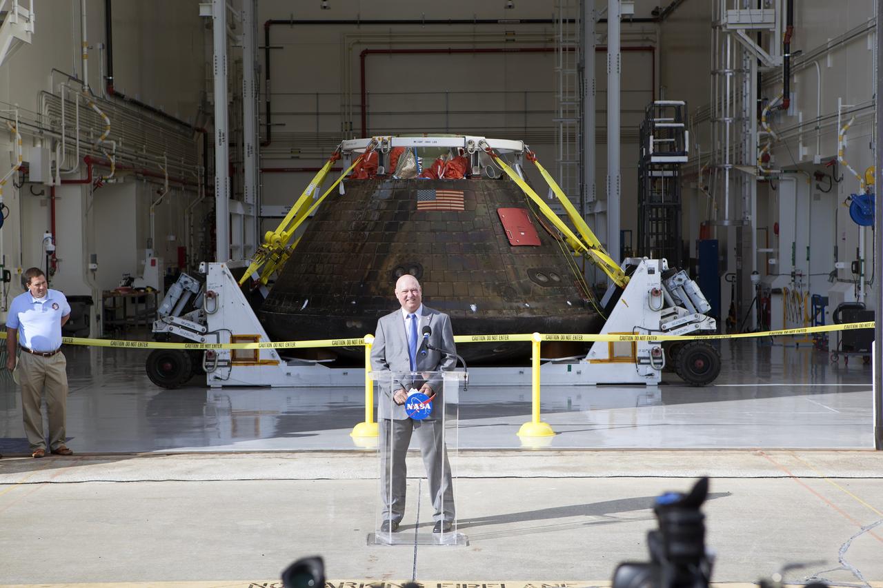 CAPE CANAVERAL, Fla. -- NASA's Orion spacecraft is viewed by members of the media at the Launch Abort System Facility at NASA's Kennedy Space Center in Florida. Kennedy News Chief Mike Curie speaks to the media during the viewing opportunity. Orion made the 8-day, 2,700 mile overland trip back to Kennedy from Naval Base San Diego in California.  Analysis of data obtained during its two-orbit, four-and-a-half hour mission Dec. 5 will provide engineers detailed information on how the spacecraft fared. The Ground Systems Development and Operations Program led the recovery, offload and transportation efforts. For more information, visit www.nasa.gov/orion. Photo credit: NASA/Dimitri Gerondidakis