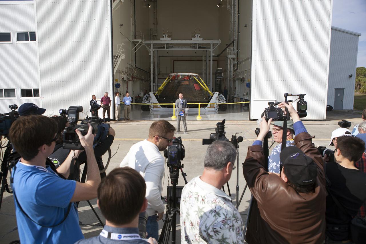CAPE CANAVERAL, Fla. -- NASA's Orion spacecraft is viewed by members of the media at the Launch Abort System Facility at NASA's Kennedy Space Center in Florida. Kennedy's News Chief Mike Curie speaks to the media during the viewing opportunity. The spacecraft's cross-country return, a 2,700 mile road trip from Naval Base San Diego to Kennedy, sets the stage for in-depth analysis of data obtained during Orion's trip to space. It will provide engineers with detailed information on how the spacecraft fared during its two-orbit, 4.5-hour flight test, completed on Dec. 5. The Ground Systems Development and Operations Program led the recovery, offload and transportation efforts. For more information, visit www.nasa.gov/orion. Photo credit: NASA/Dimitri Gerondidakis