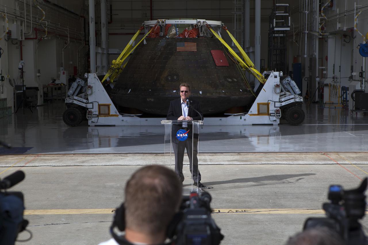 CAPE CANAVERAL, Fla. -- Lockheed Martin Manager Jules Schneider speaks to members of the media during a viewing of NASA's Orion spacecraft at the Launch Abort System Facility at NASA's Kennedy Space Center in Florida. The spacecraft's cross-country return, a 2,700 mile road trip from Naval Base San Diego to Kennedy, sets the stage for in-depth analysis of data obtained during Orion's trip to space. It will provide engineers with detailed information on how the spacecraft fared during its two-orbit, 4.5-hour flight test, completed on Dec. 5. The Ground Systems Development and Operations Program led the recovery, offload and transportation efforts. For more information, visit www.nasa.gov/orion. Photo credit: NASA/Dimitri Gerondidakis