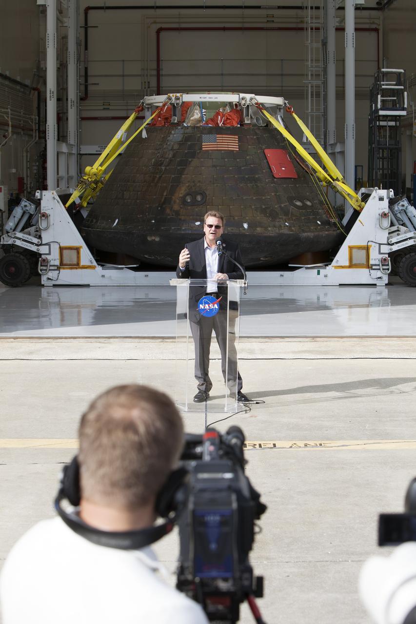 CAPE CANAVERAL, Fla. -- Lockheed Martin Manager Jules Schneider speaks to members of the media during a viewing of NASA's Orion spacecraft at the Launch Abort System Facility at NASA's Kennedy Space Center in Florida. The spacecraft's cross-country return, a 2,700 mile road trip from Naval Base San Diego to Kennedy, sets the stage for in-depth analysis of data obtained during Orion's trip to space. It will provide engineers with detailed information on how the spacecraft fared during its two-orbit, 4.5-hour flight test, completed on Dec. 5. The Ground Systems Development and Operations Program led the recovery, offload and transportation efforts. For more information, visit www.nasa.gov/orion. Photo credit: NASA/Dimitri Gerondidakis